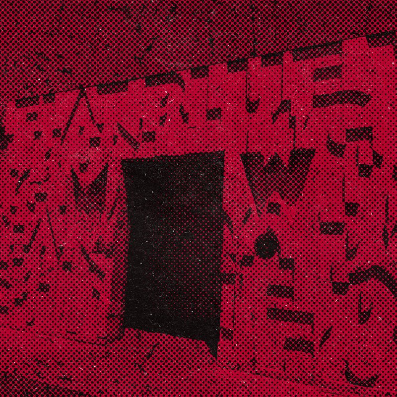 Graffiti-covered wall with a dark doorway in the center.