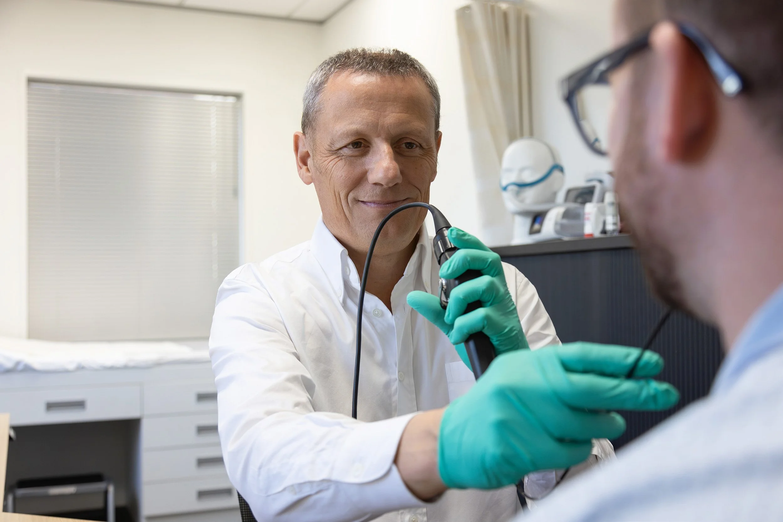 A specialist sleep and respiratory physician performing a test on a patient
