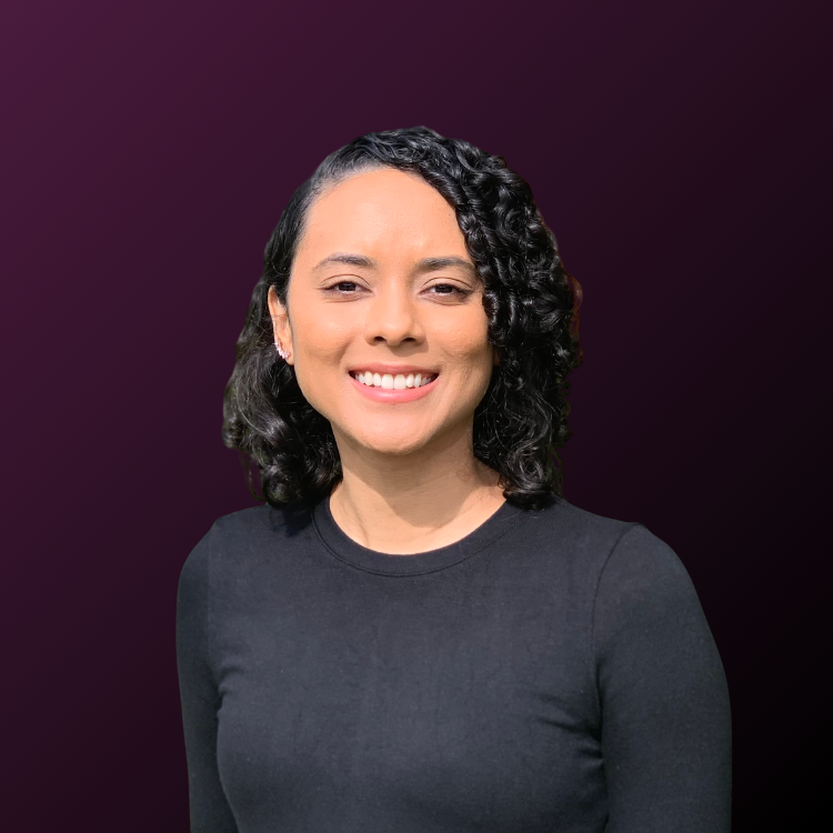 Headshot of smiling female founder with medium-length curly hair wearing a black sweater.