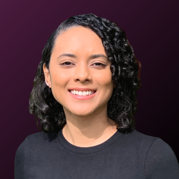 Headshot of smiling female founder with medium-length curly hair wearing a black sweater.