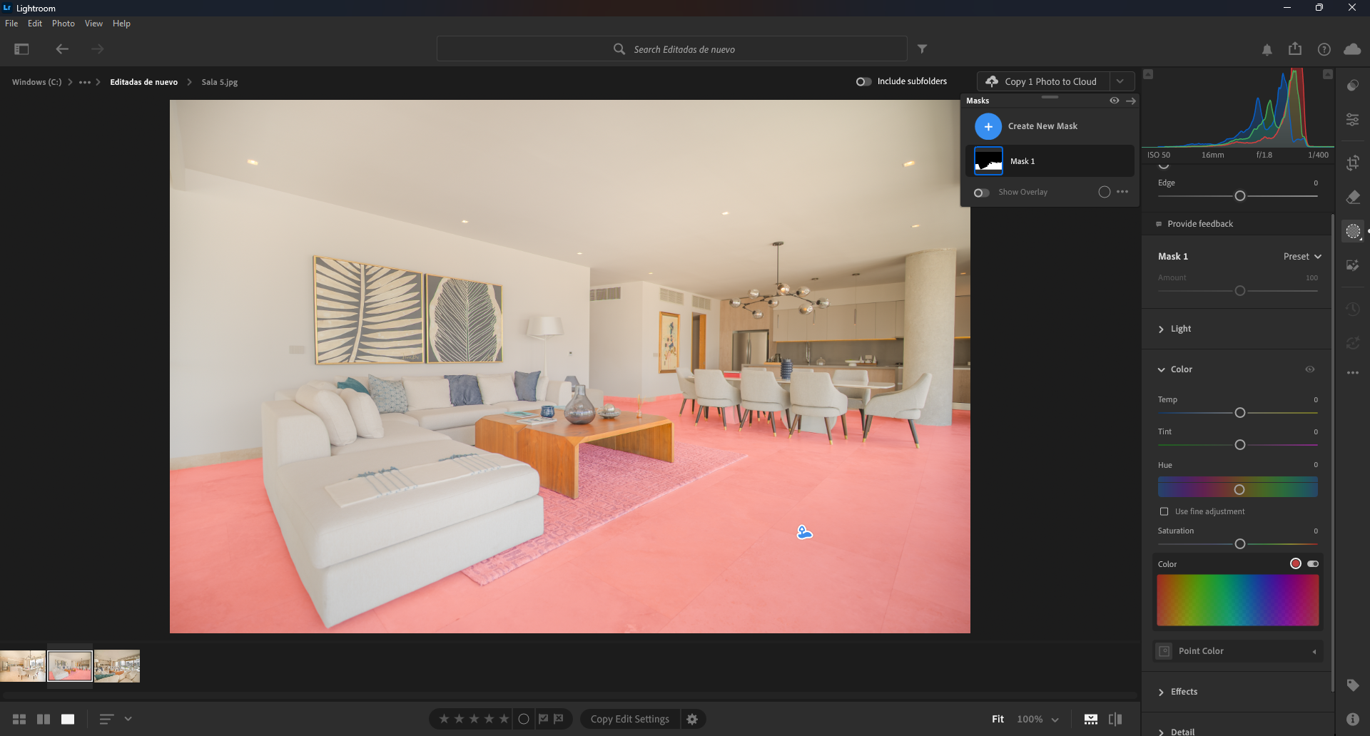 Screenshot of an editing process: Living room and dining area in a modern apartment with white walls, artwork, a white sectional sofa, a wooden coffee table, a round dining table with beige chairs, and a kitchen in the background.