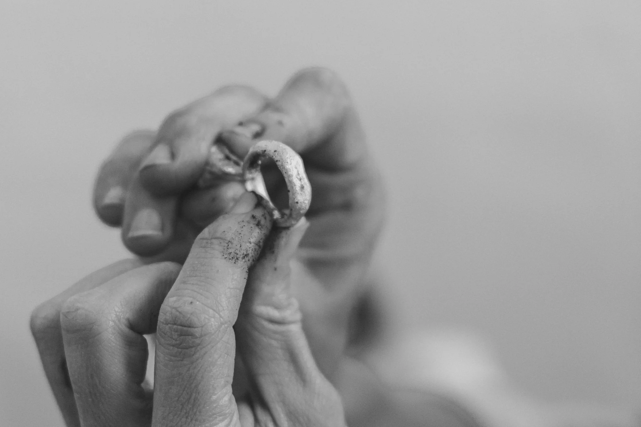 Hands holding a raw casting of a ring