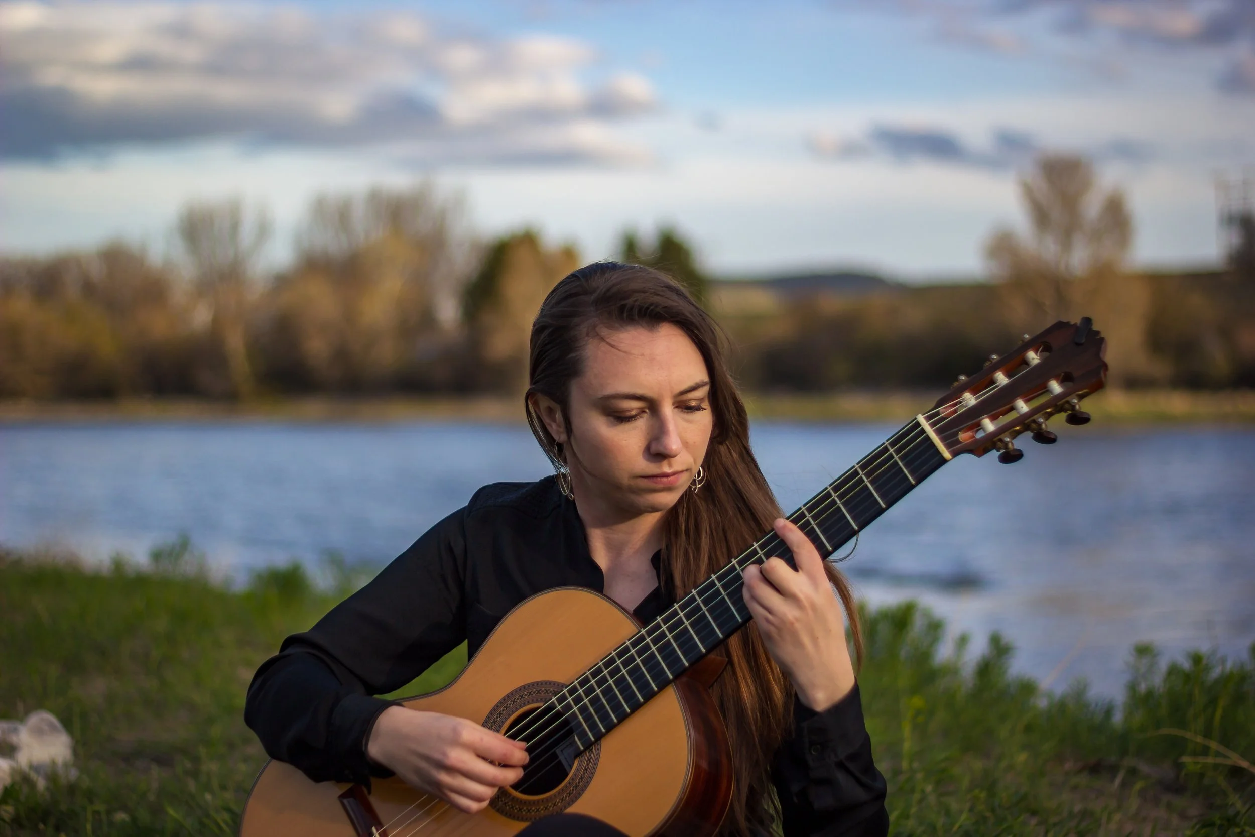 Yellowstone Guitar Academy founder Devin Matthews plays along the Yellowstone River.