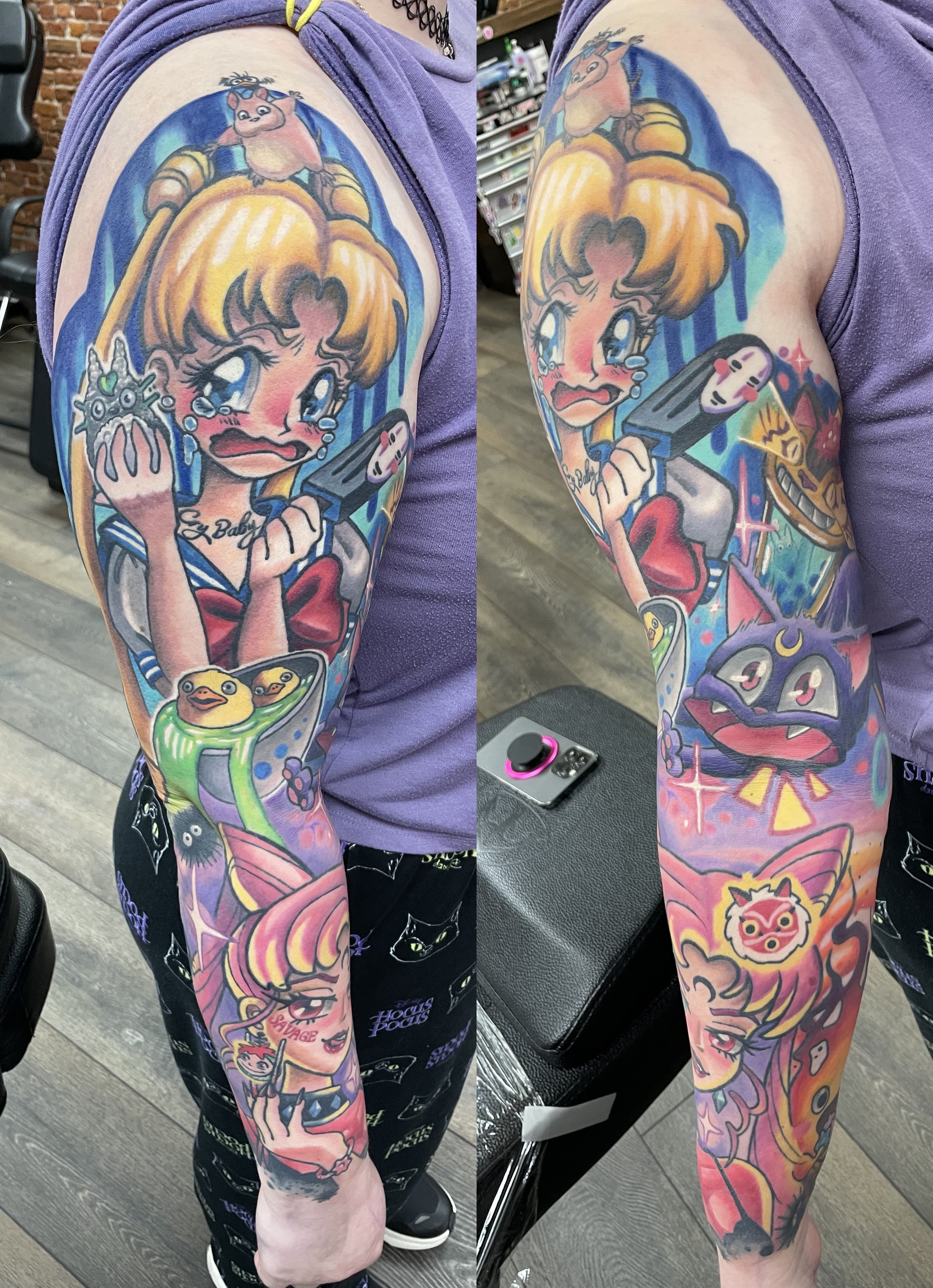 Colorful tattoo sleeve featuring various anime-inspired characters and symbols, including a crying girl with blonde hair, heart motifs, a cute animal face, and various abstract and decorative elements.