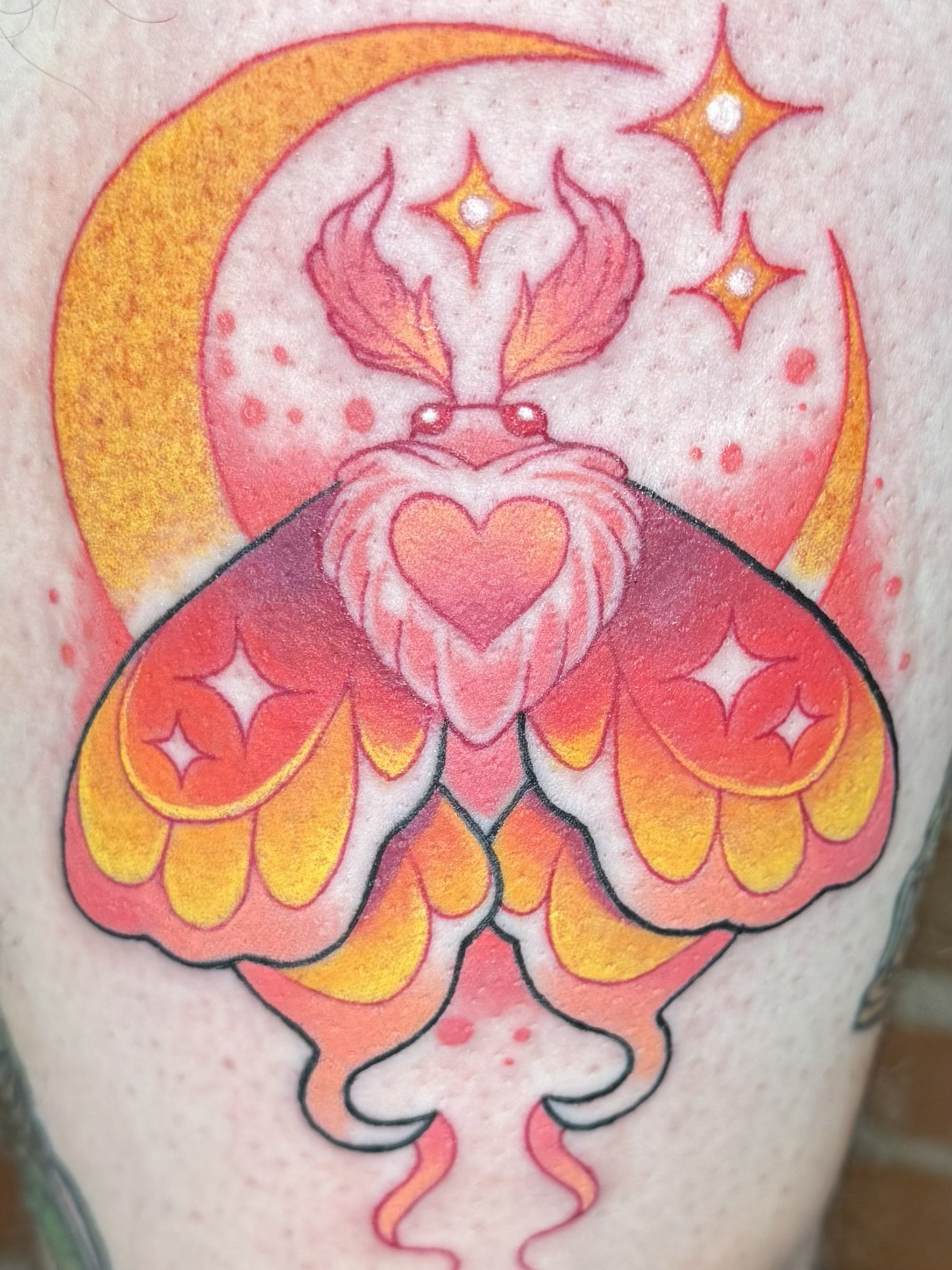 Colorful tattoo of a stylized abstract design with a heart, flames, stars, and drips in pink, orange, yellow, and black on skin.