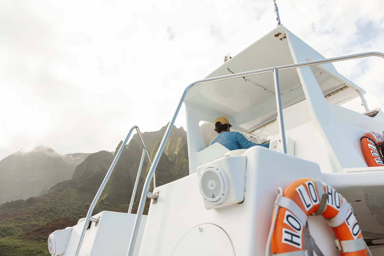 Photo of one of Holo Holo Charters boats on the coast of Kauai, Hawaii, photographed by Rhianon Brown Photography