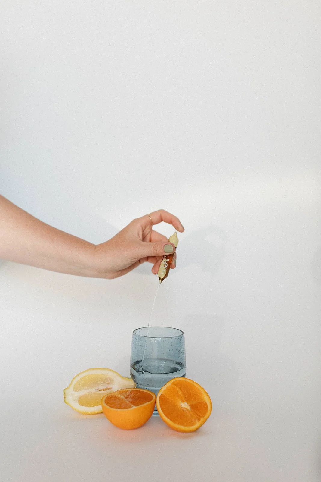 image of a wellness set up with a glass and oranges for motherland wellness brand shoot with rhianon brown photography