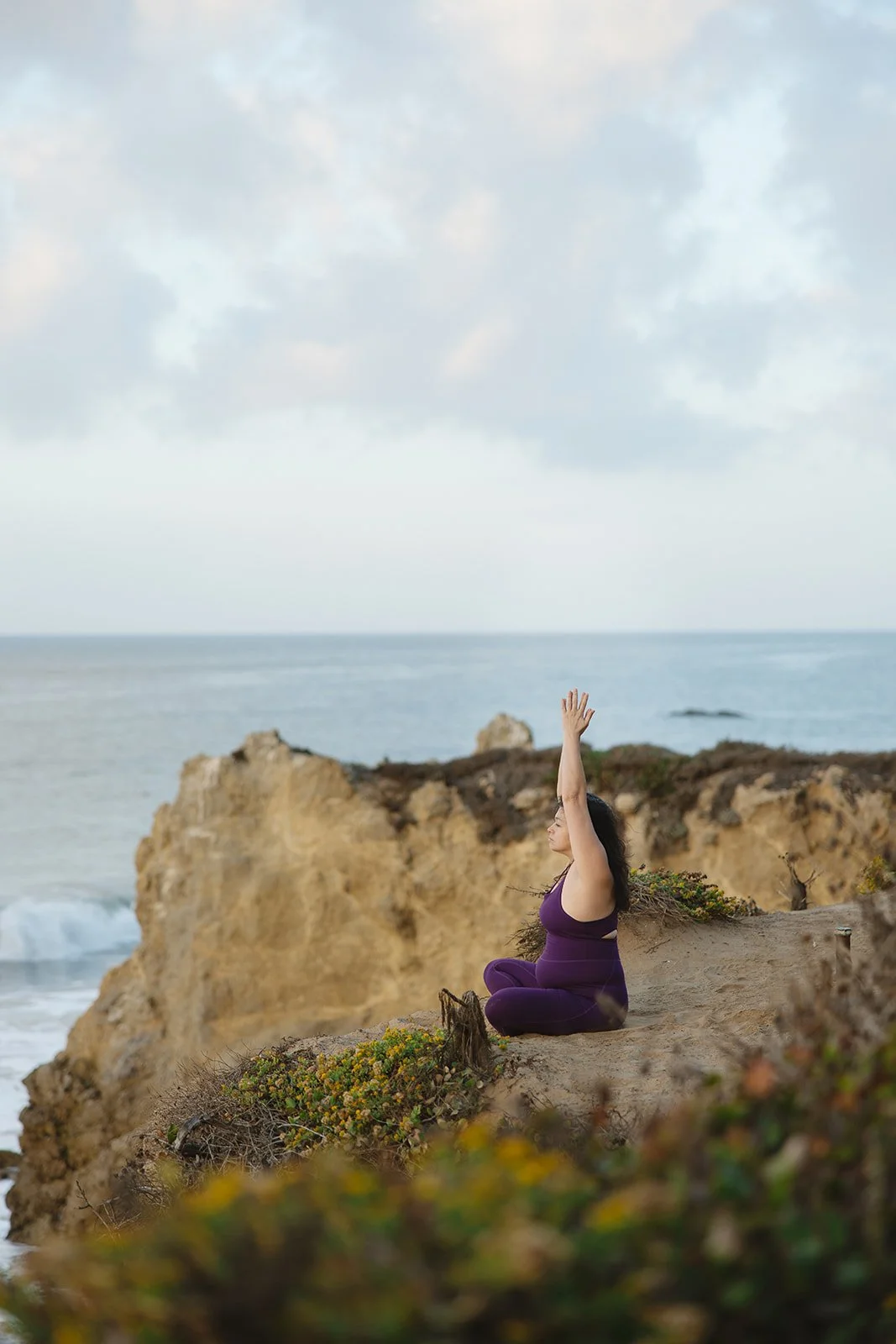 Brand photo of woman doing yoga on a cliffside photographed by Rhianon Brown Photography