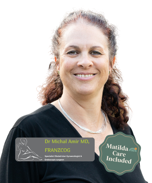 Portrait of Dr. Michal Amir, MD, with text indicating he's a specialist in obstetrics, gynecology, endoscopic surgery, and includes Matilda Care. The woman has light skin, curly brown hair, and is smiling, wearing a black top and a silver necklace.