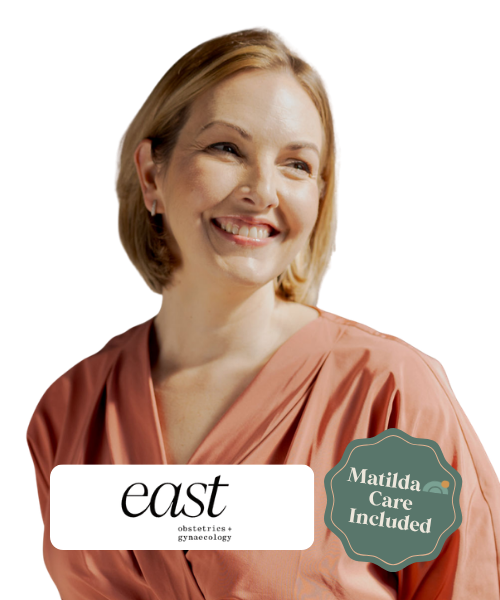 Smiling woman with short blonde hair wearing a peach-colored top, with a logo that says 'east obstetrics + gynecology' and a badge indicating 'Matilda Care Included'.