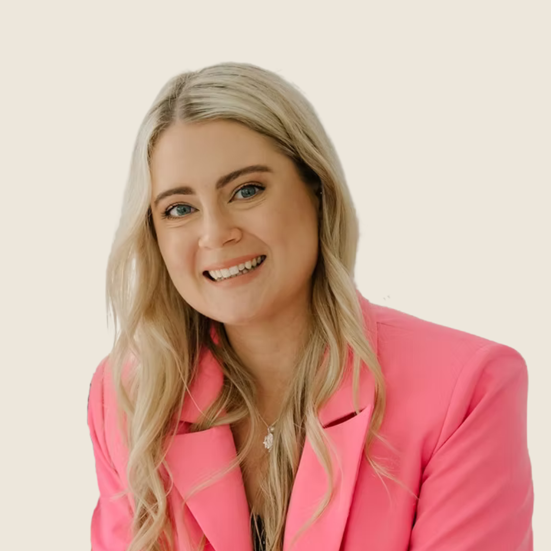 Headshot of Rachel Gearon, a blonde woman in a pink blazer.