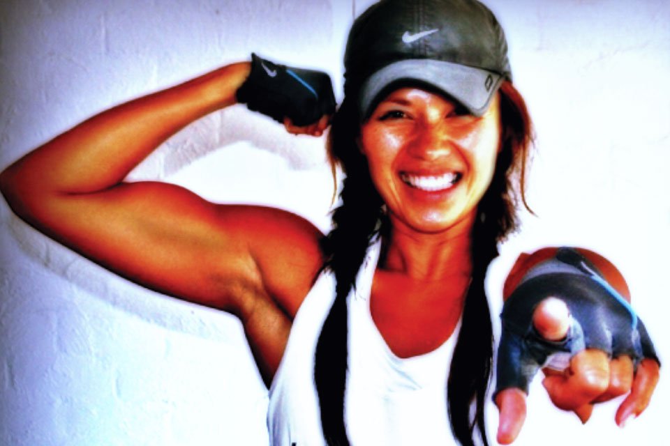 Di Robertson flexing and pointing at the camera