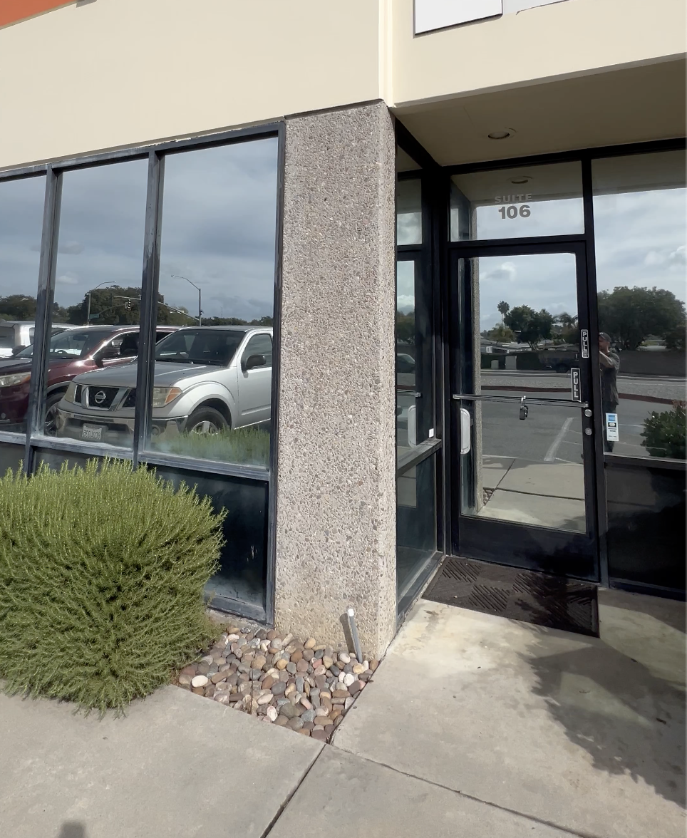 Exterior of a commercial building with large glass windows that have window tint to provide privacy and UV ray blocks for it's employee's working inside the office done by Reborn Motorwerks.
