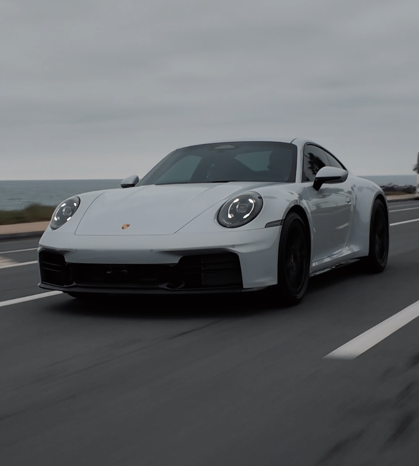 A silver Porsche sports car with paint protection film (PPF) done by Reborn Motorwerks.