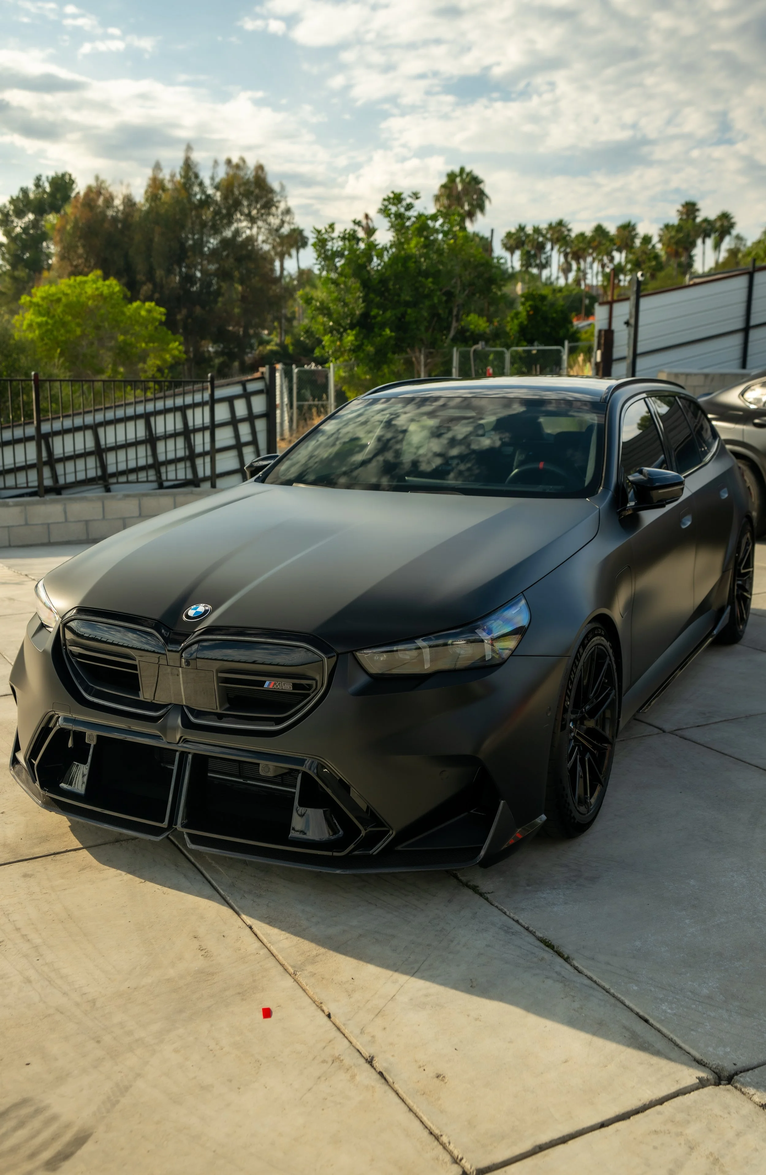 A BMW M5 hatchback with matte black vinyl wrap to complete transform it's look and protect its original paint done by Reborn Motorwerks.