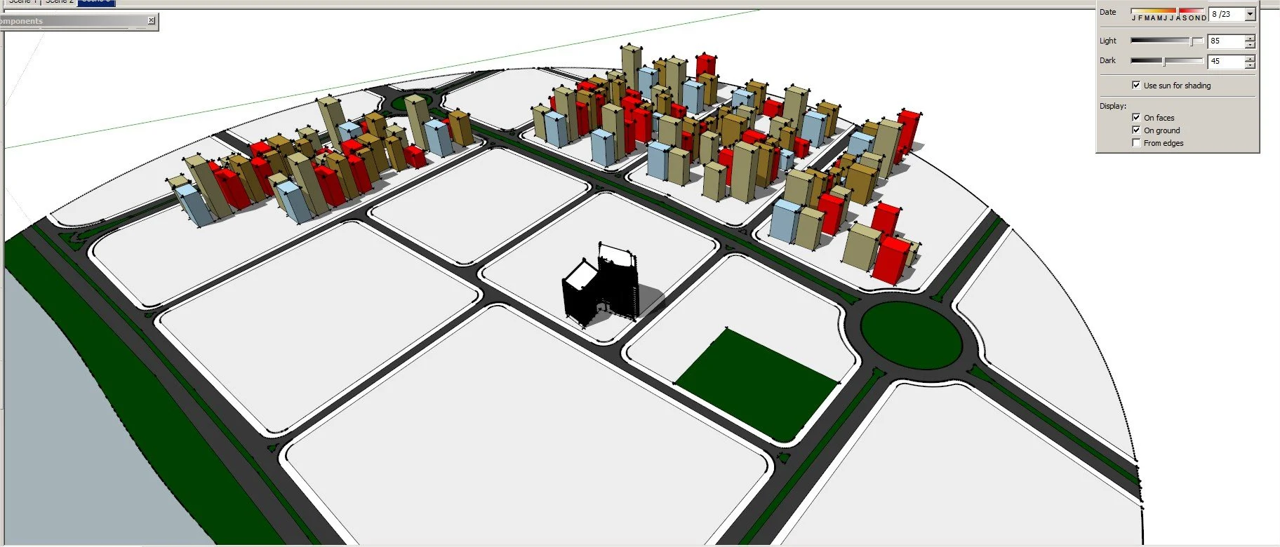A 3D city model with various buildings and roads, including a roundabout, shaded to indicate sunlight and shadows.