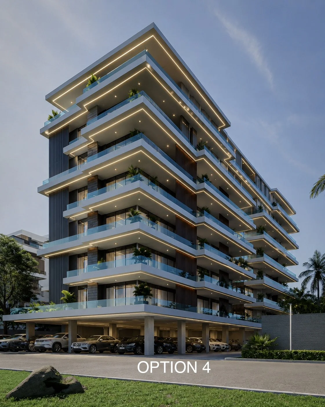 A modern, multi-story residential building with glass balconies and exterior lighting at dusk, with a parking area underneath and greenery around.