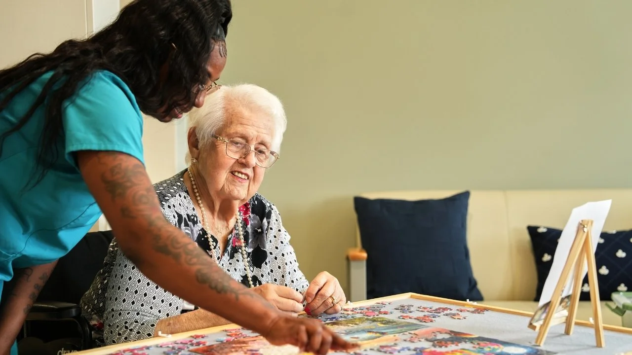 nurse with resident doing memory care activity