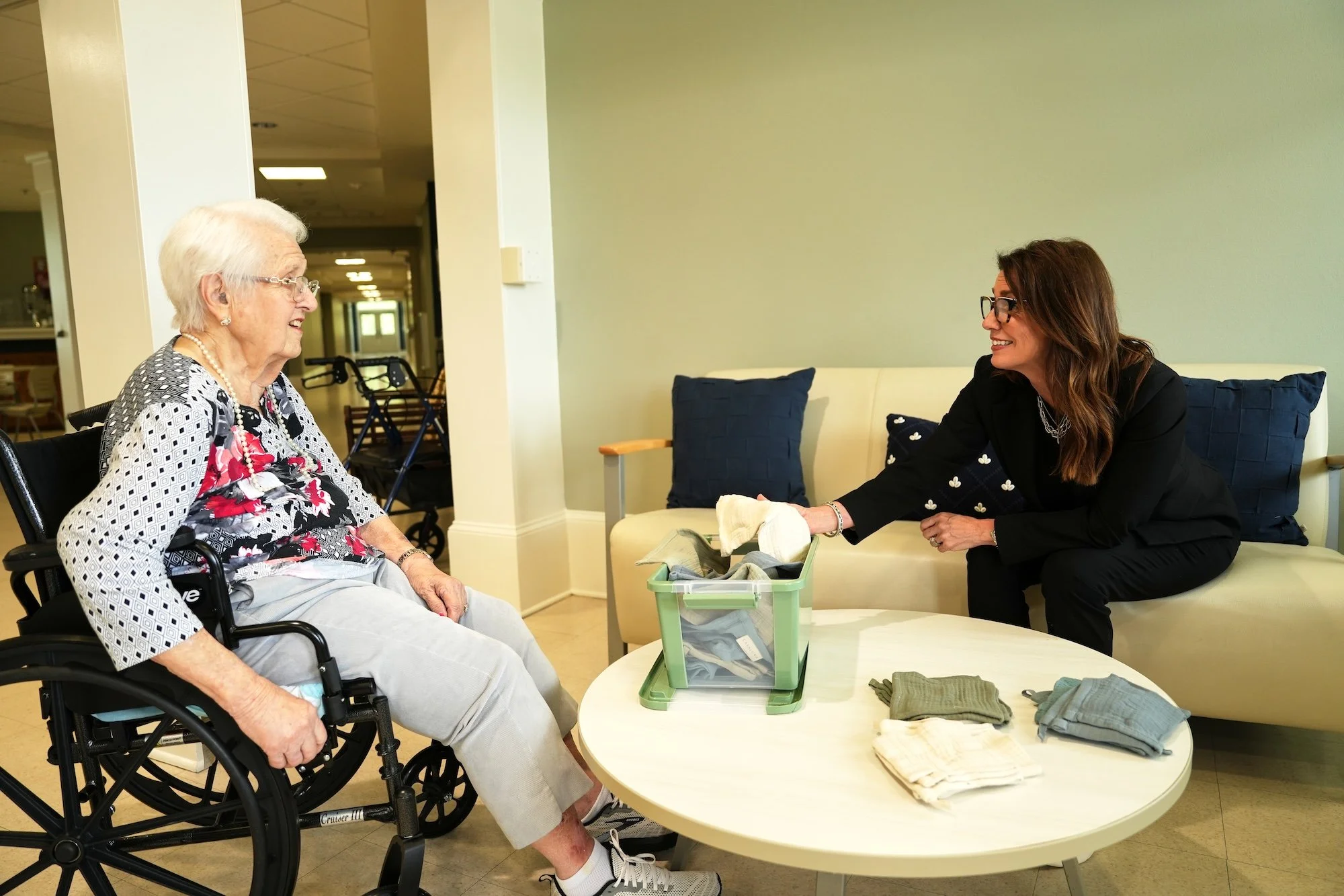executive director showing resident a memory care exercise