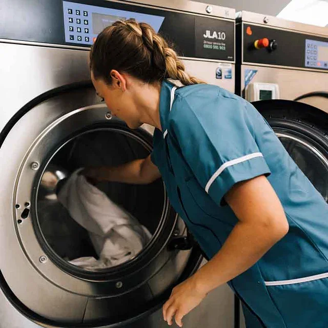 staff member operating laundry machine