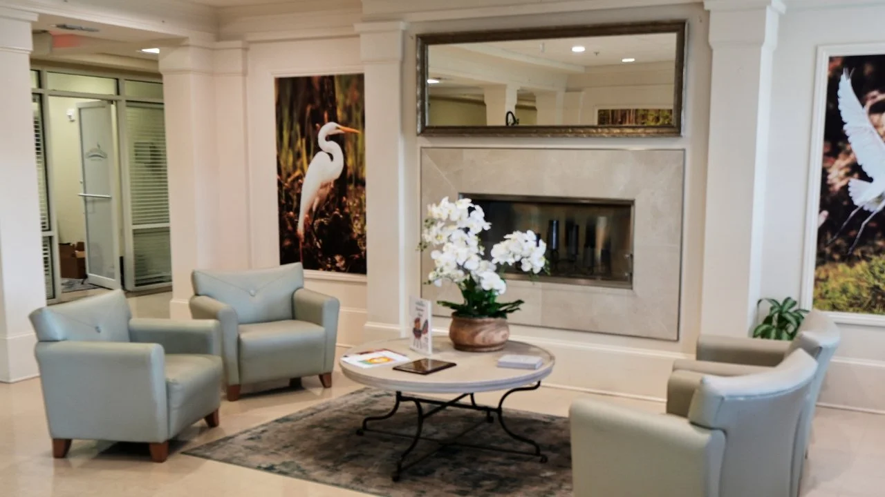 image of lobby with comfortable seating and flowers on coffee table
