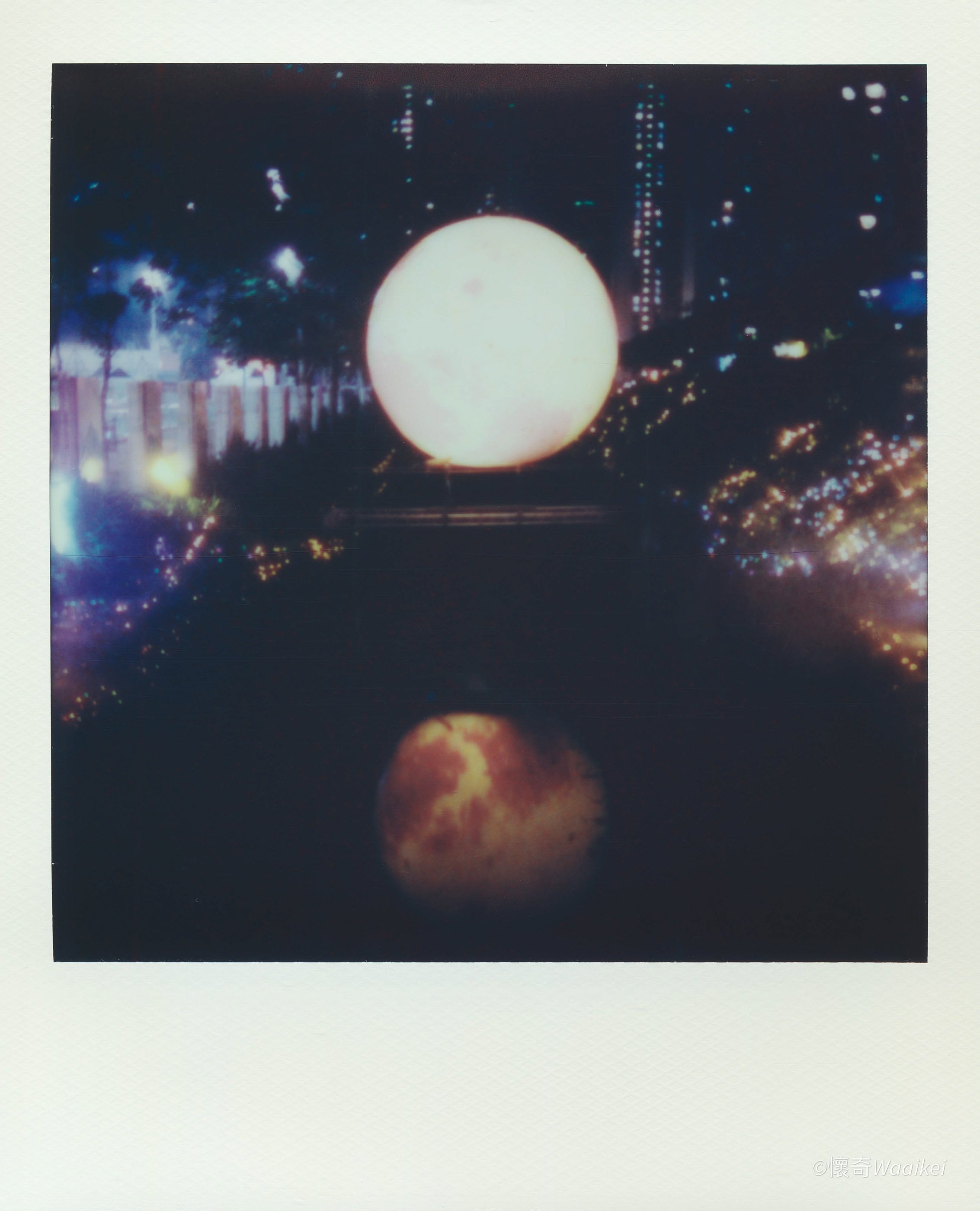 Nighttime scene featuring bright, glowing spherical objects and city lights in the background.