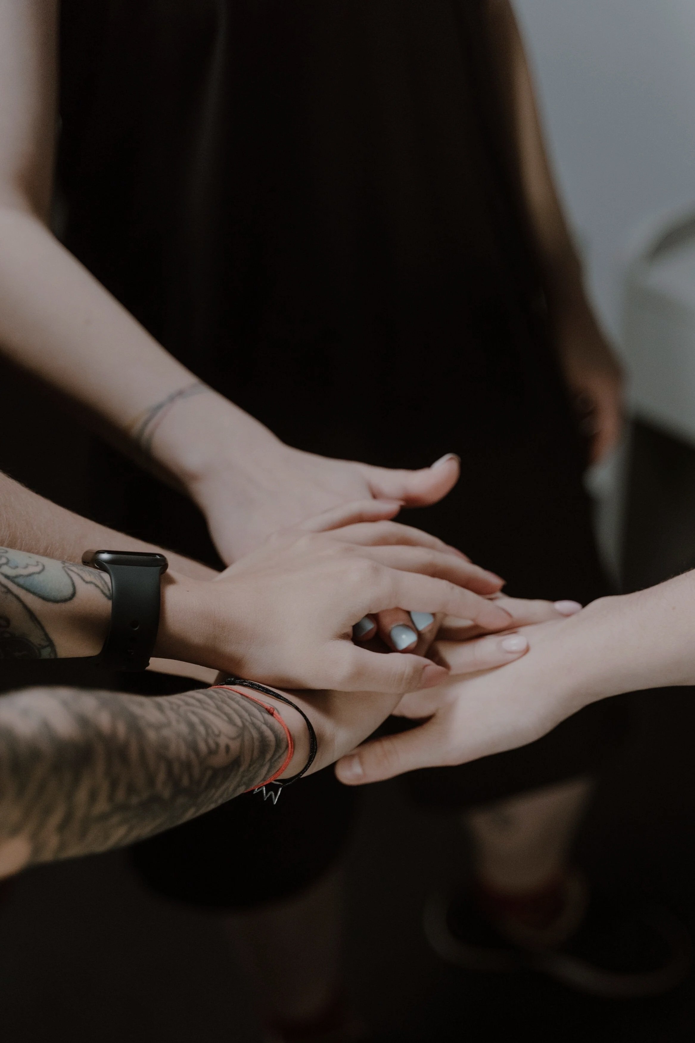 Group placing their hands together in a supportive gesture