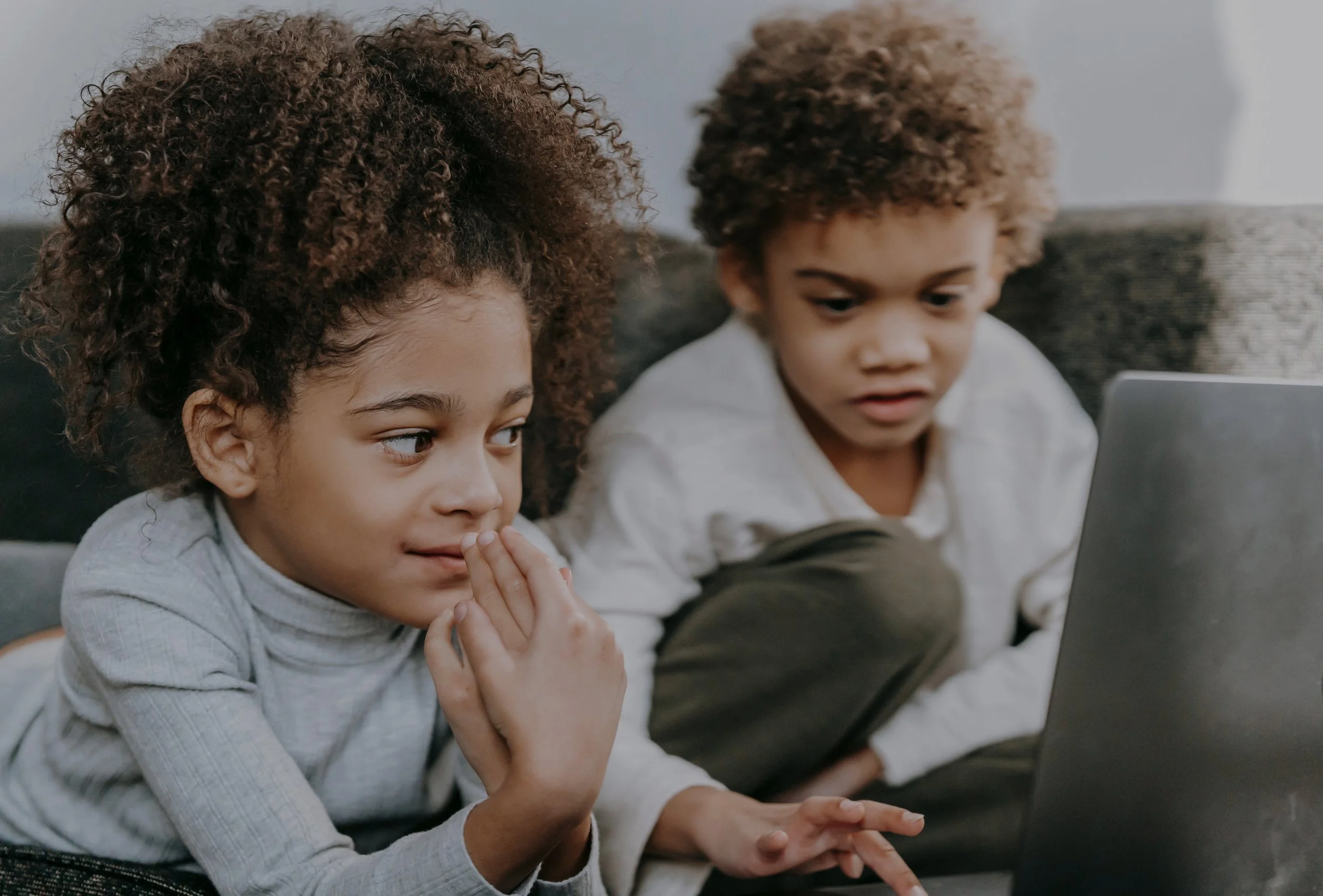 Two children sitting and interacting together