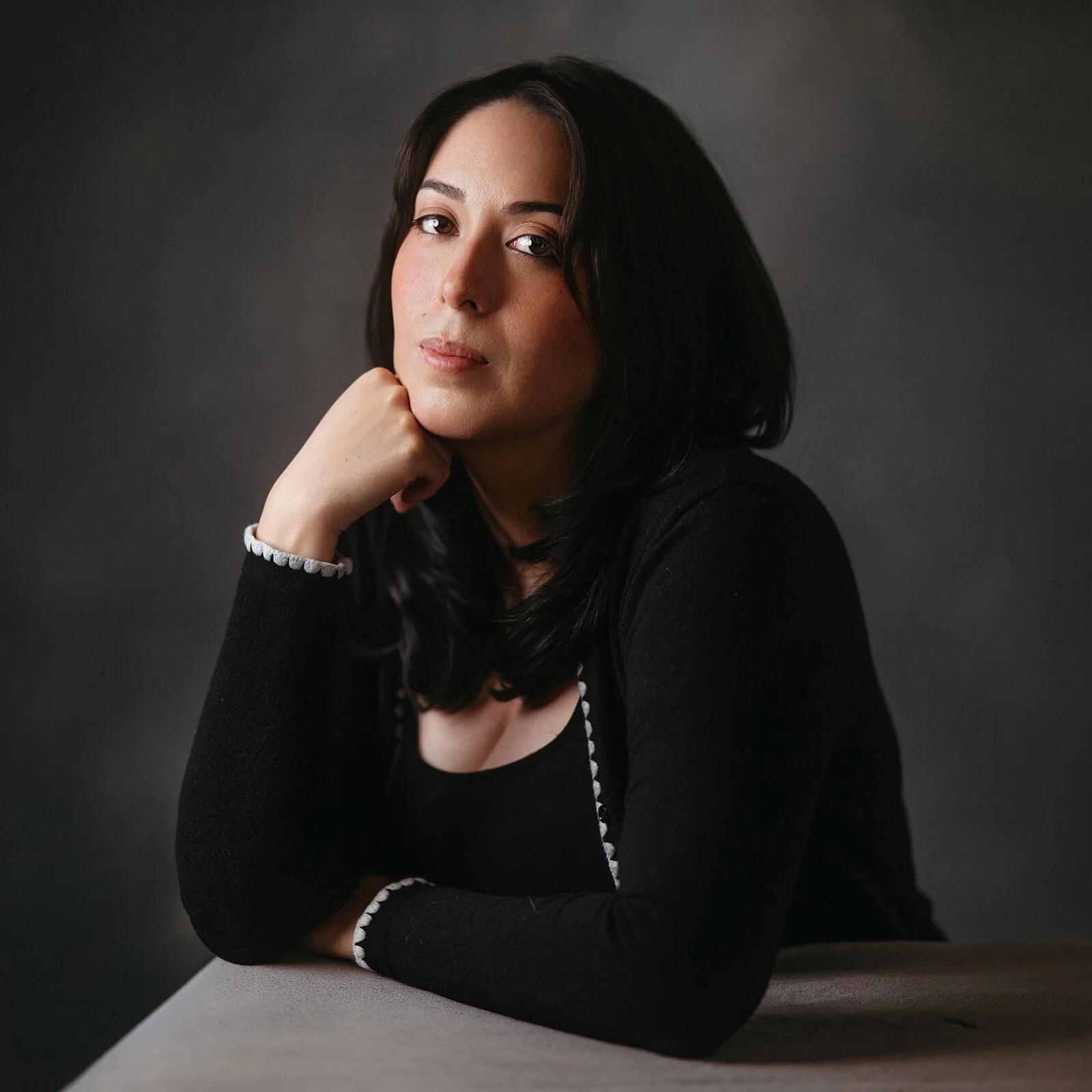 Portrait of Elena Wu resting her chin on her hand