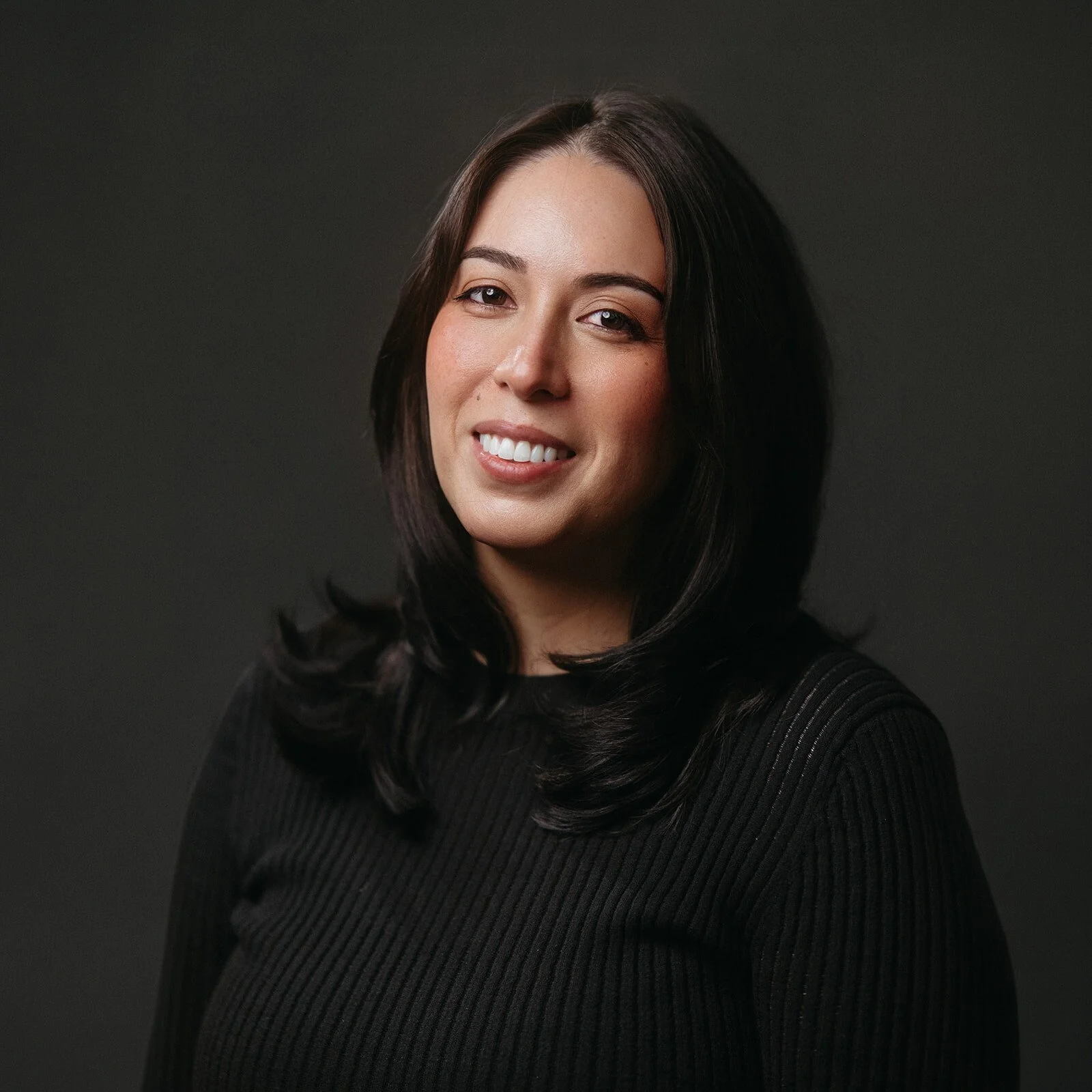 Professional headshot of Elena Wu smiling against a dark background
