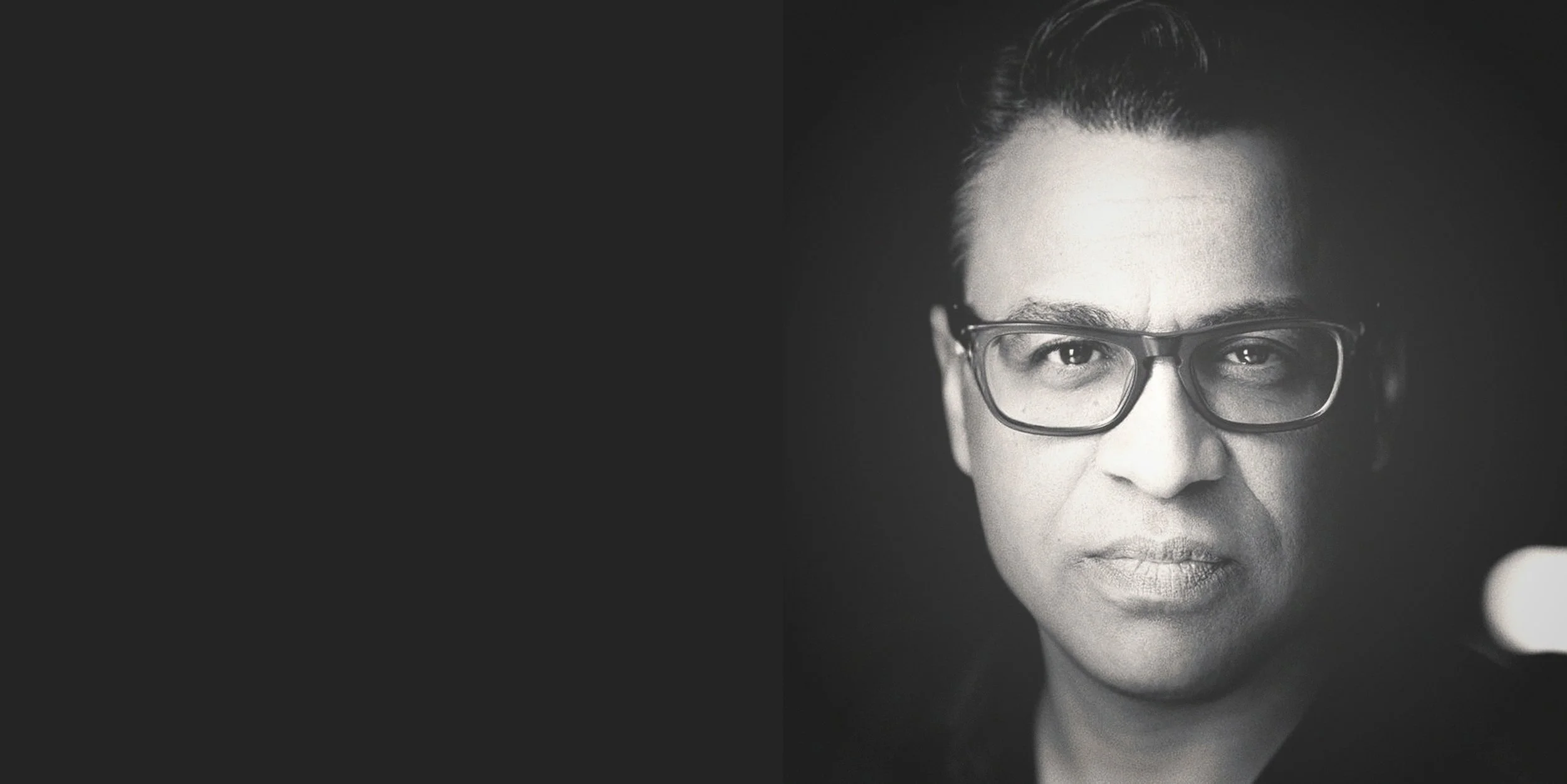 Nathaniel Perry, poet and voice-over artist in Charlotte, NC — black-and-white headshot with glasses