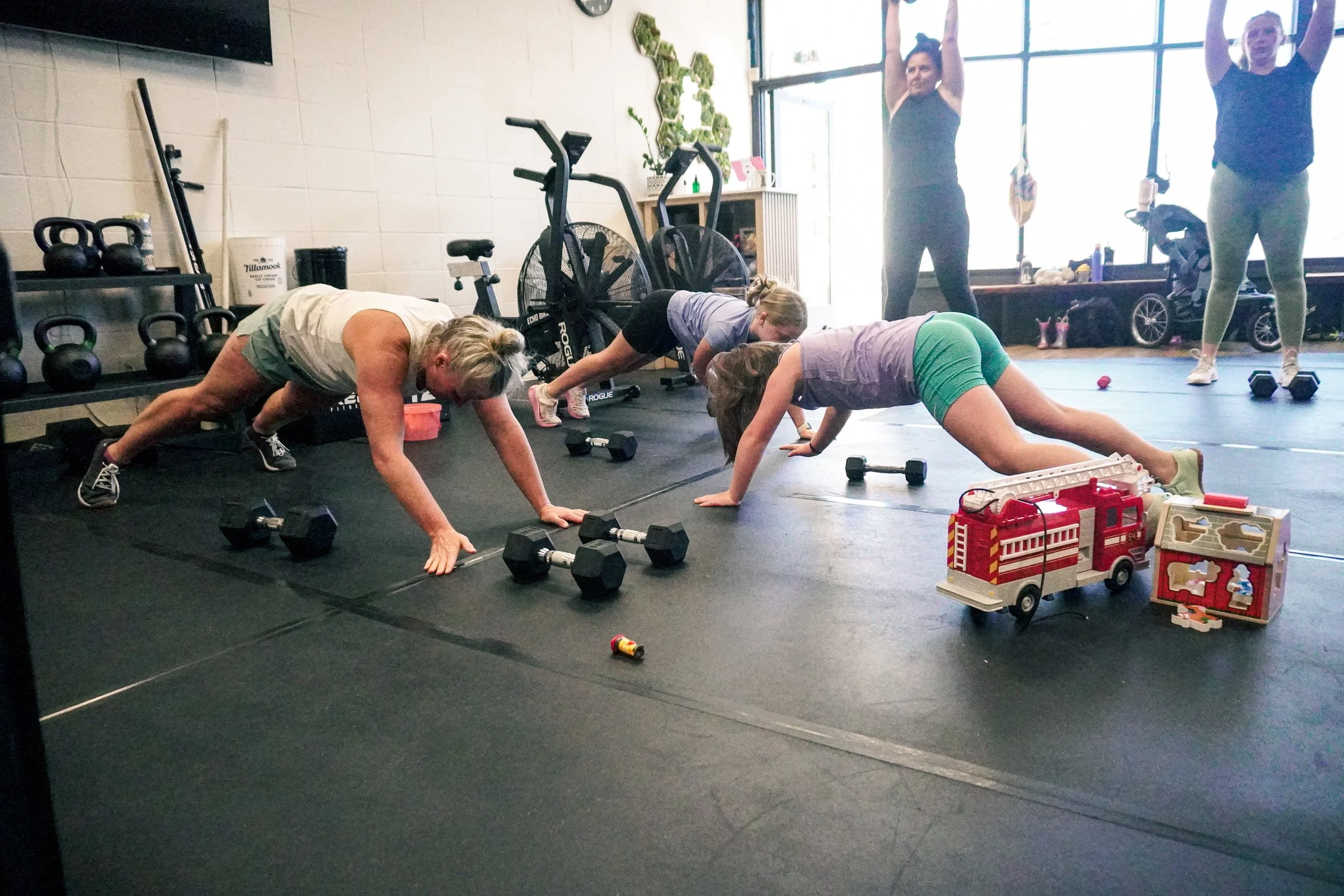 woman and children in a push up position