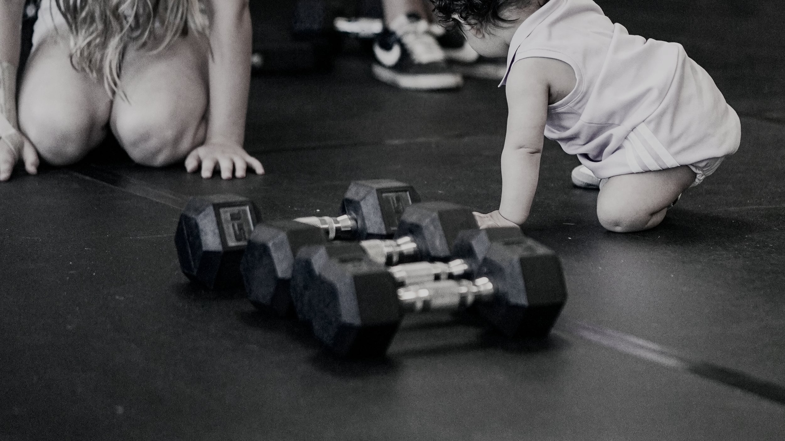 children playing on the floor in a women's only child friendly gym