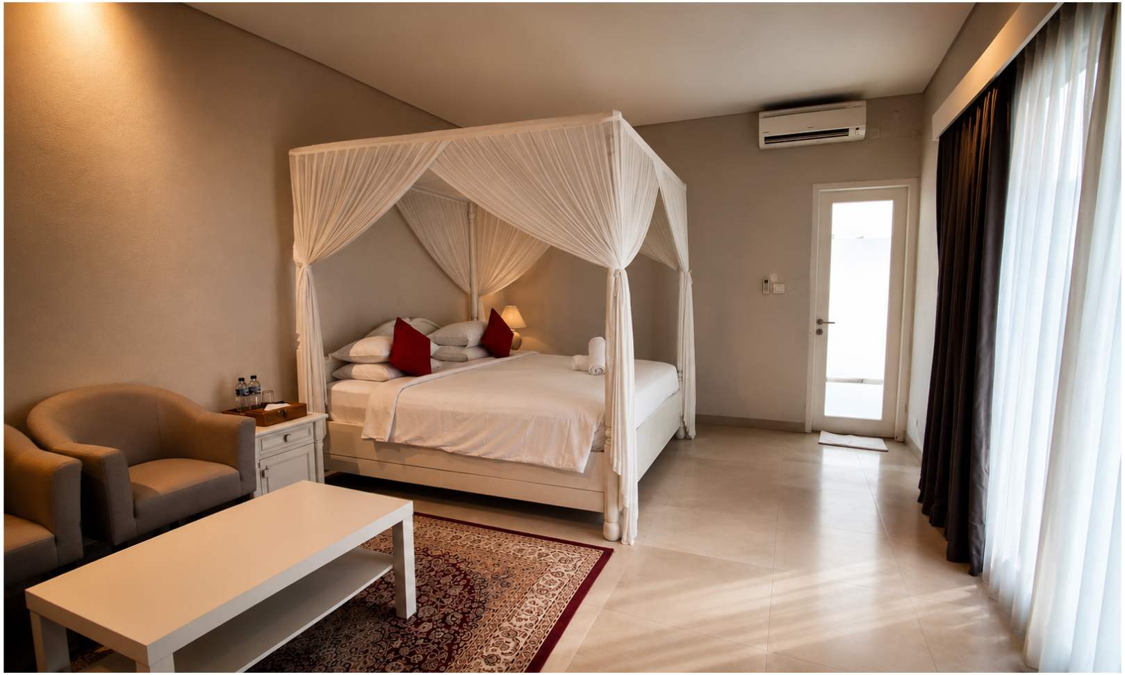 Living room with beige chairs, a white coffee table, a TV mounted on the wall, dark curtains, and a door with blinds.