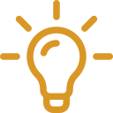 Gold outline of a light bulb with rays emanating from it