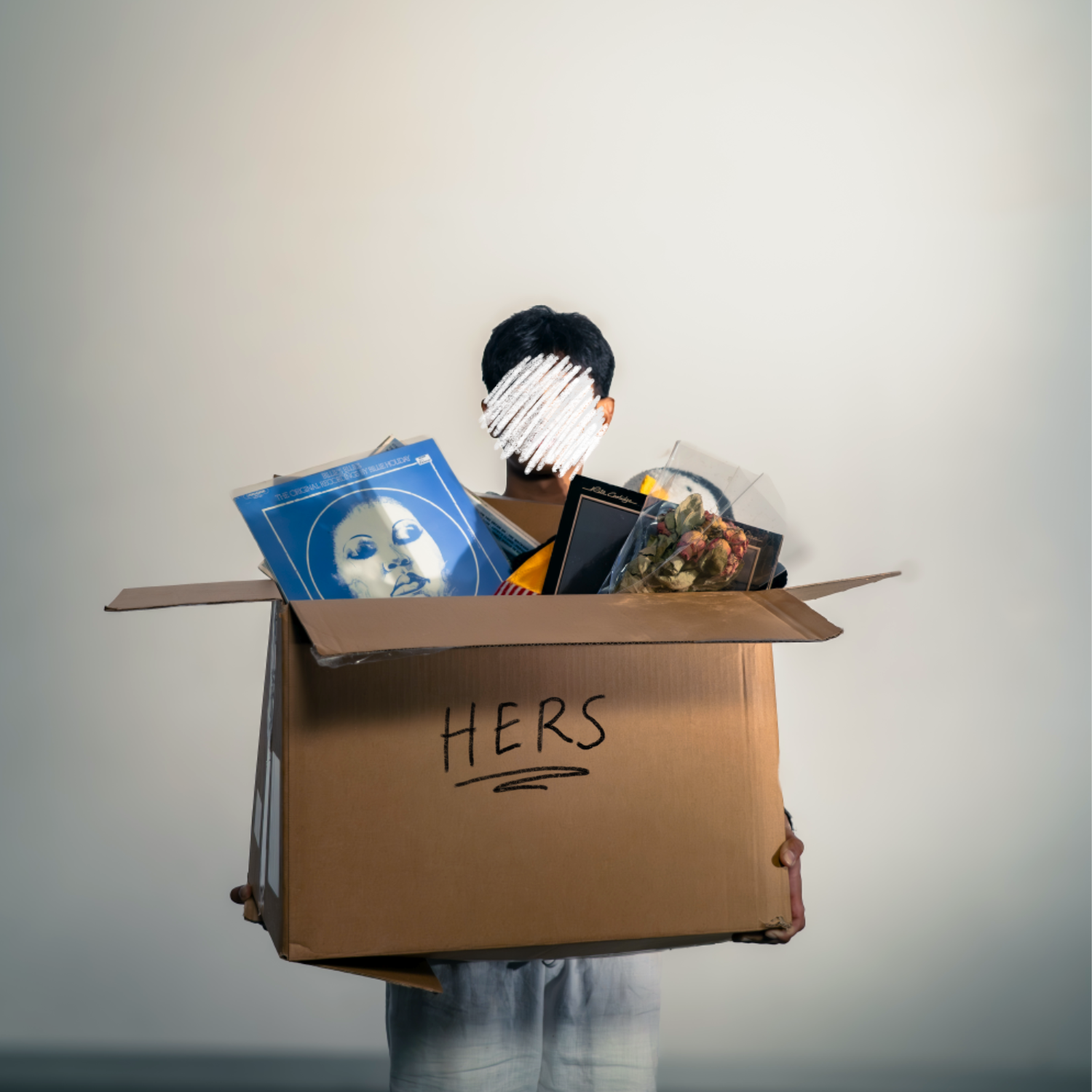 Person holding a large cardboard box labeled 'HERS' filled with records, artwork, and a bouquet of flowers, against a plain background.