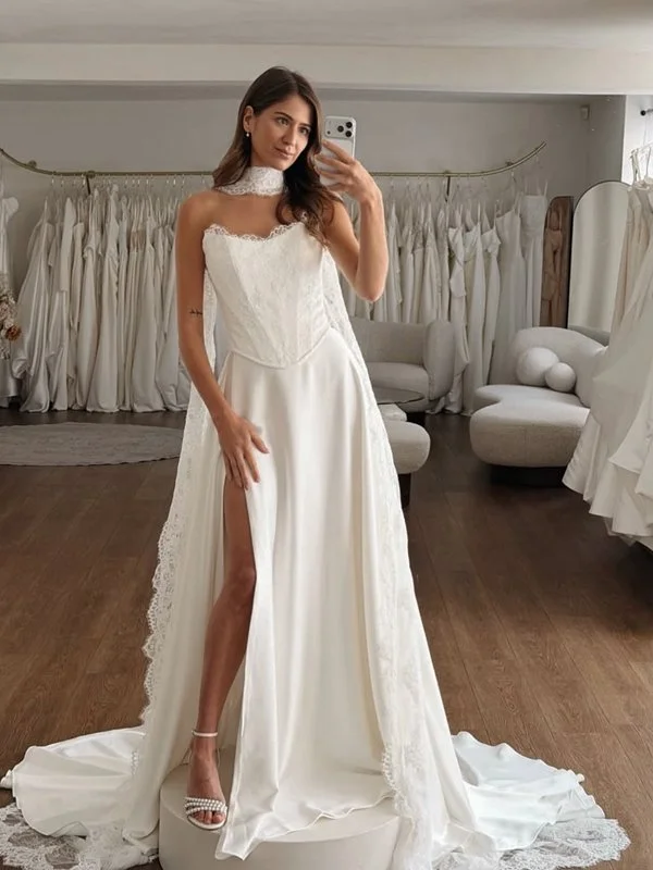 Woman in a wedding dress taking a mirror selfie in a bridal boutique.