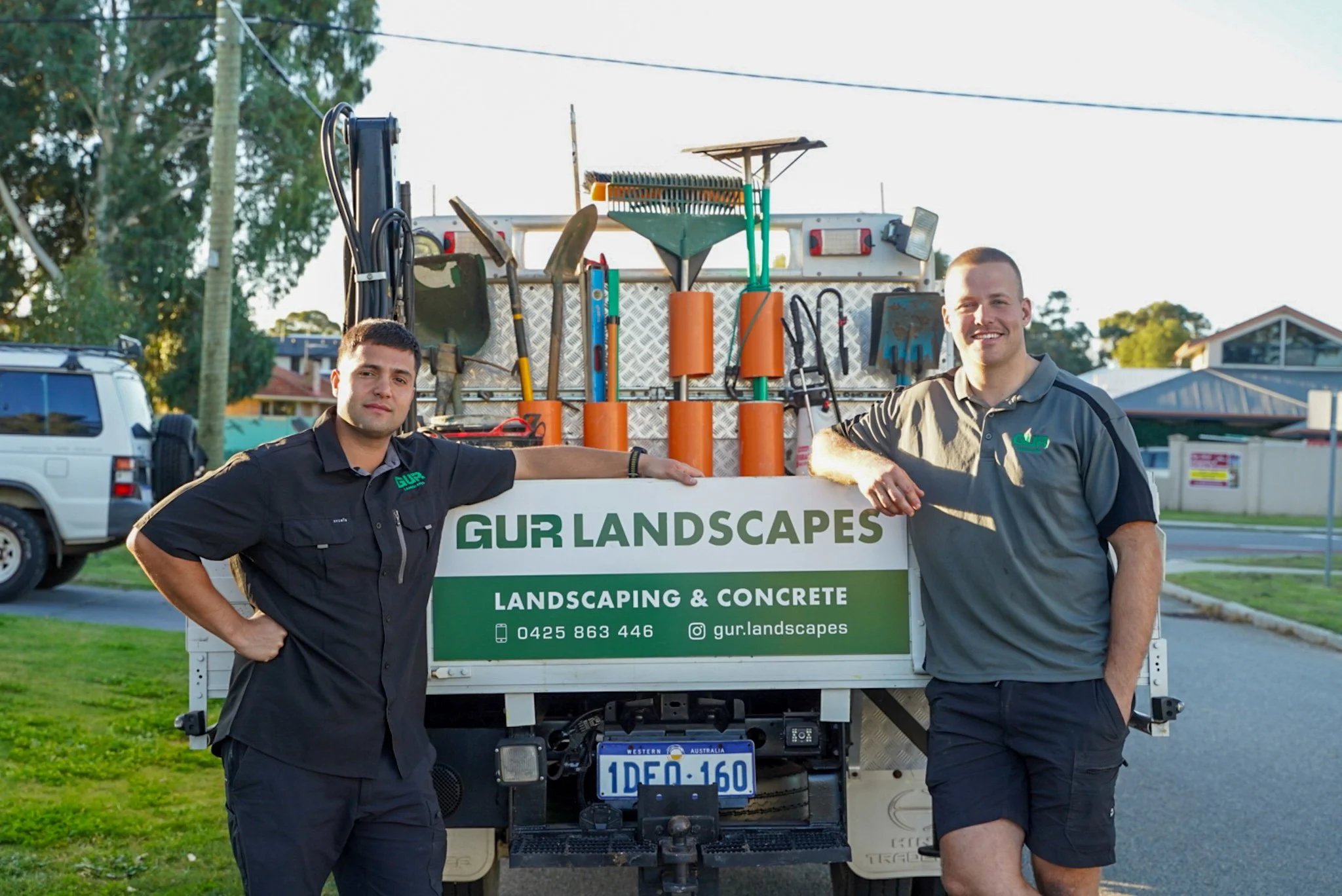 Dan and Luke, founders of GUR, standing at their ute smiling