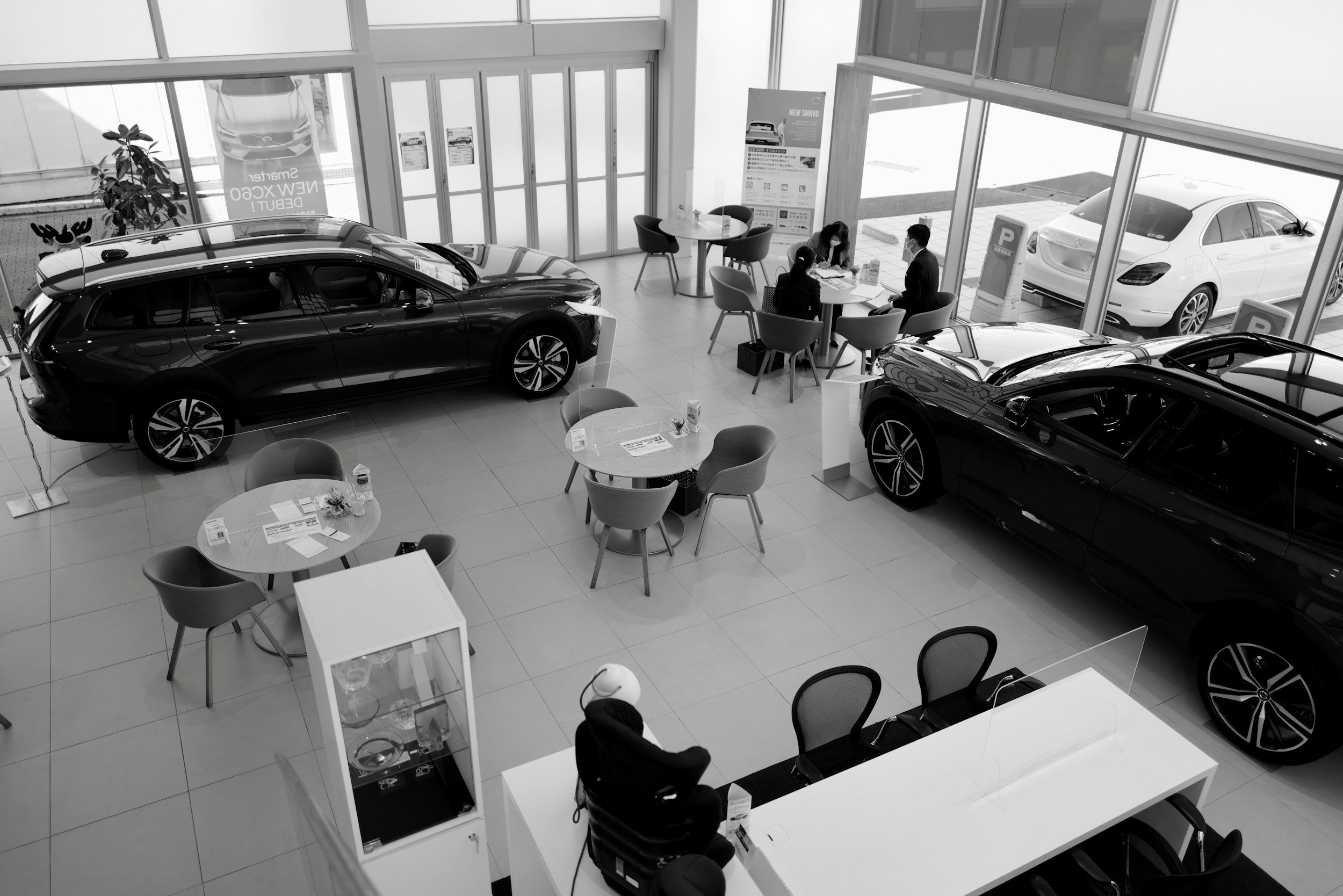Automotive dealership showroom with vehicles and sales desks