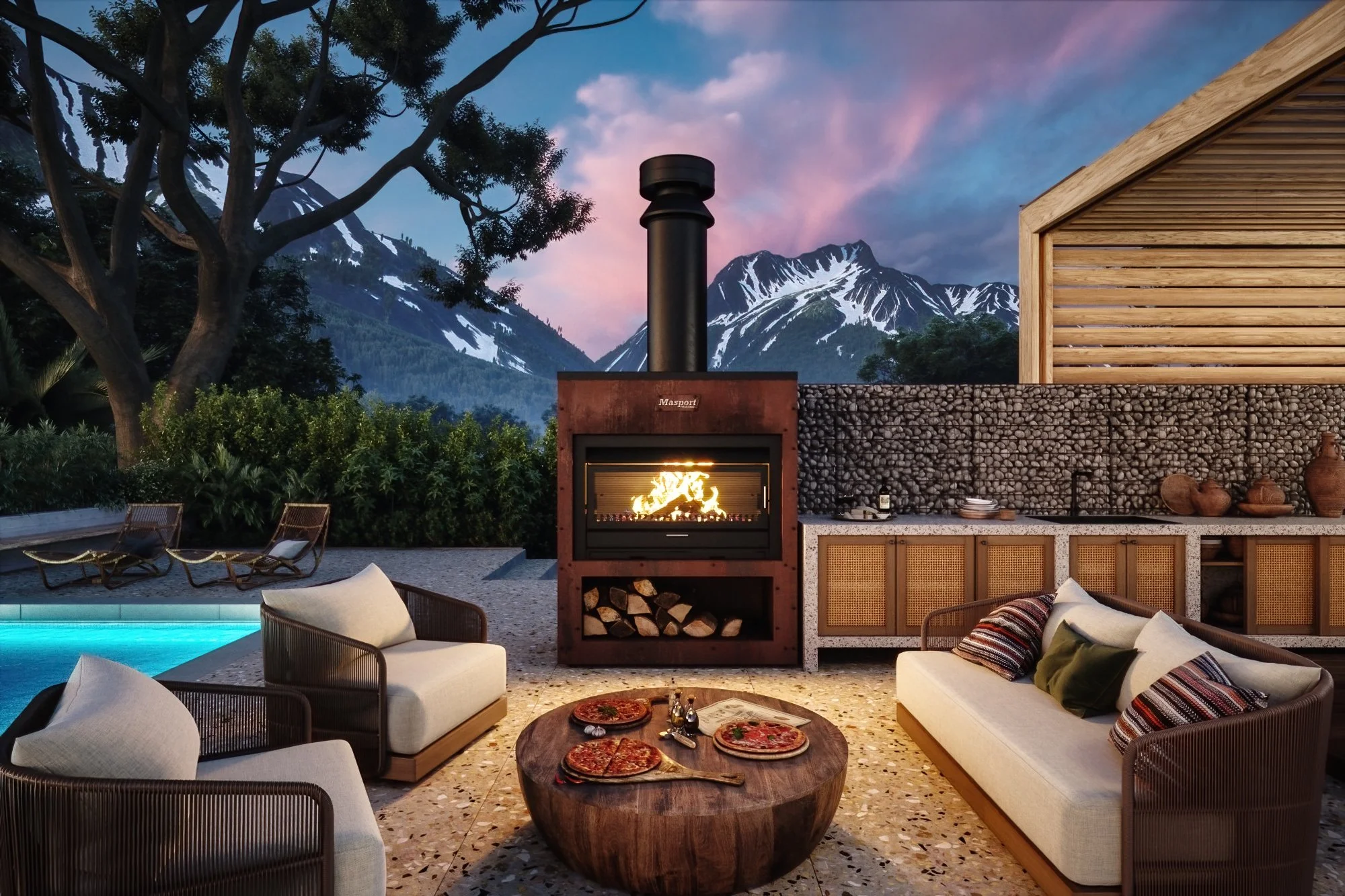 Outdoor patio scene with seating, a fireplace, mountain view, trees, and a building with wooden siding, during sunset.