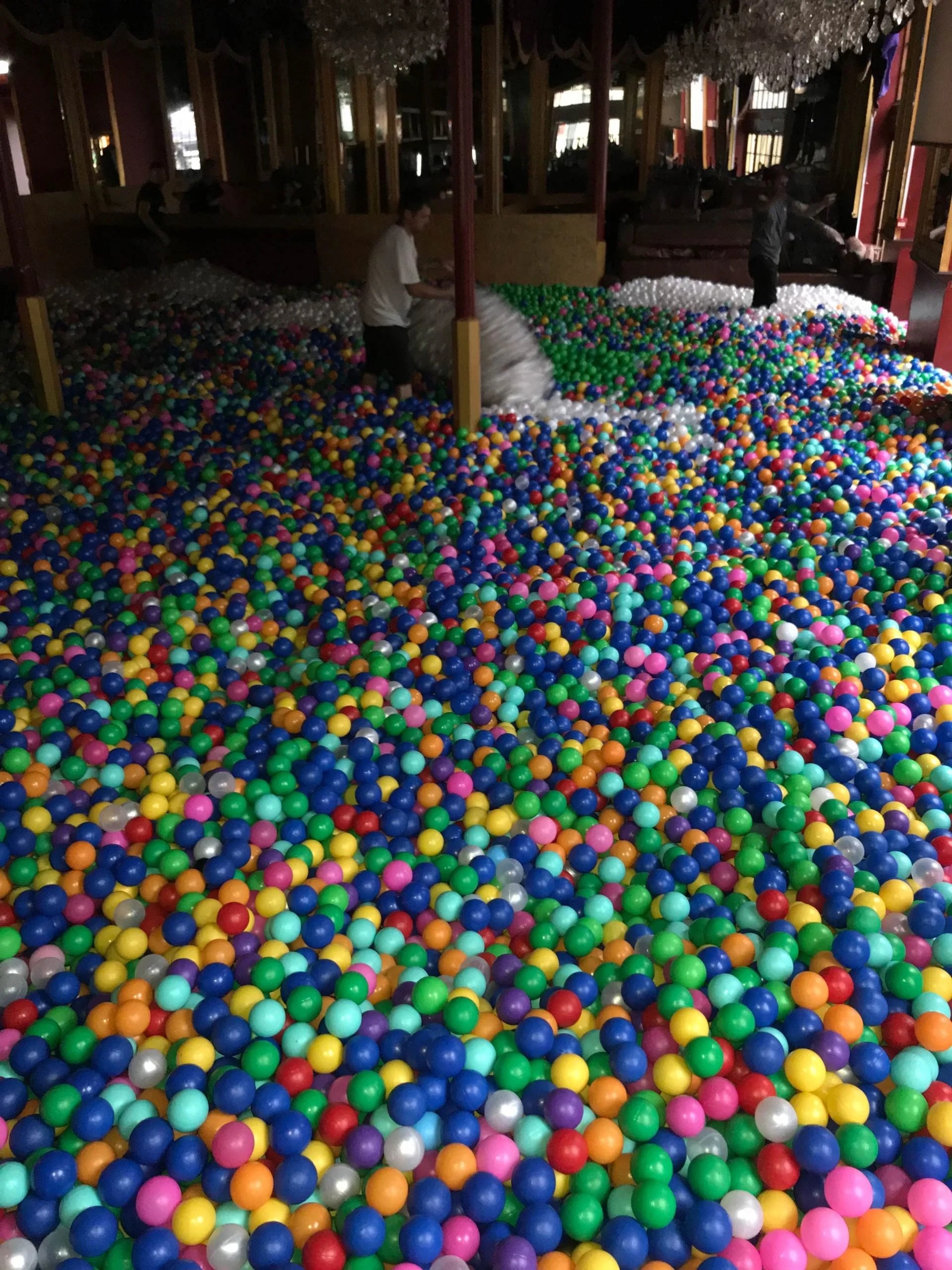 Multicoloured ball pit room fill covering the floor of a large barn venue
