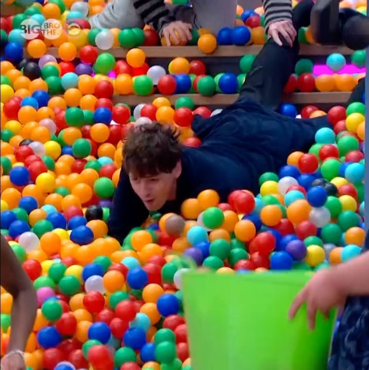 Housemate diving through the balls during the Big Brother challenge