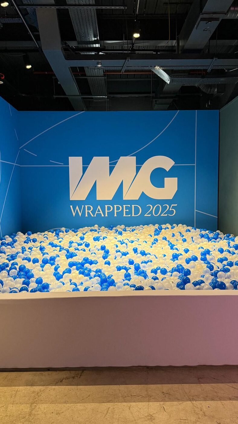 Custom-built IMG Wrapped 2025 branded ball pit filled with blue, white and pearl balls