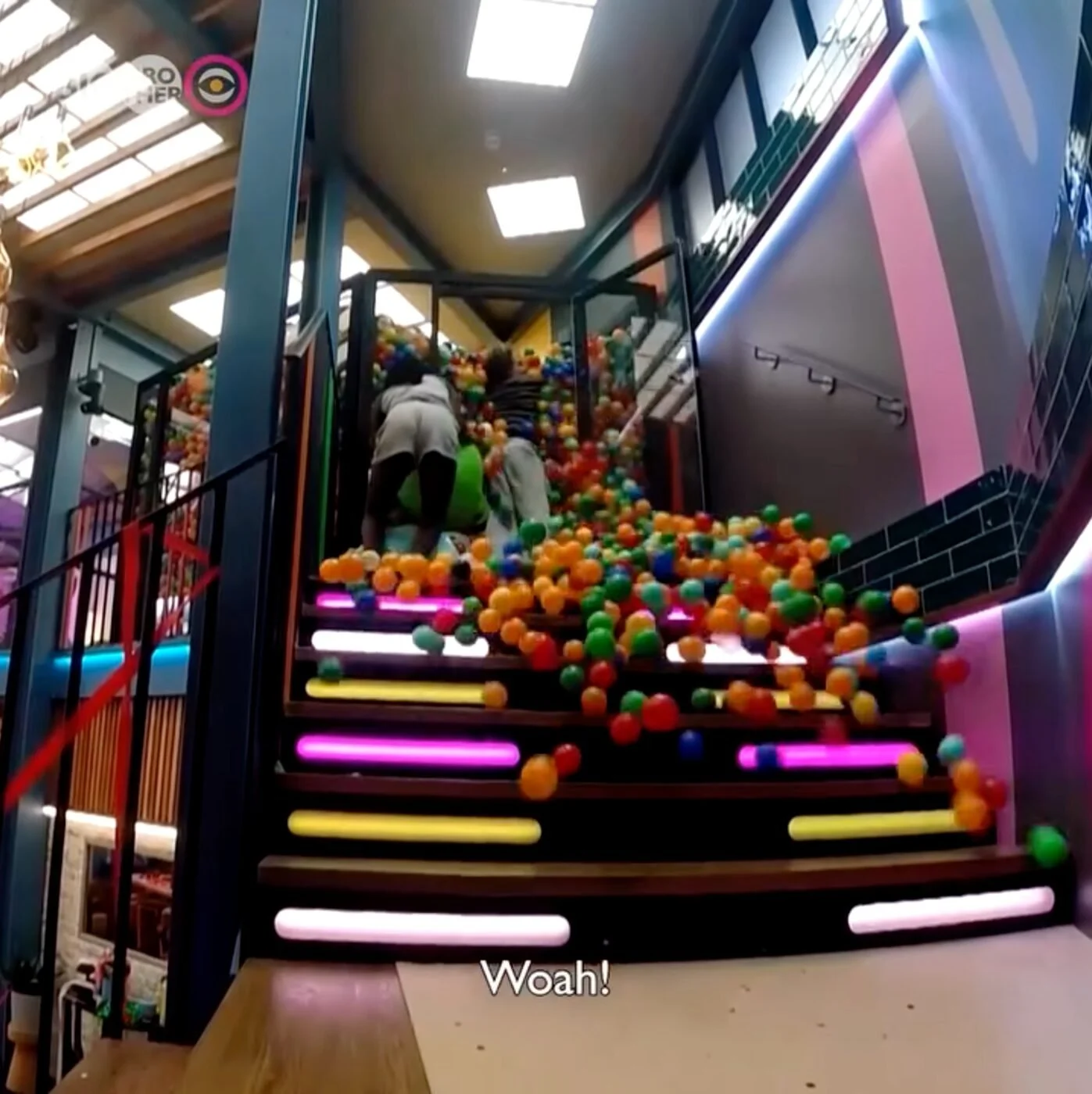 Thousands of multicoloured balls cascading down the Big Brother house staircase