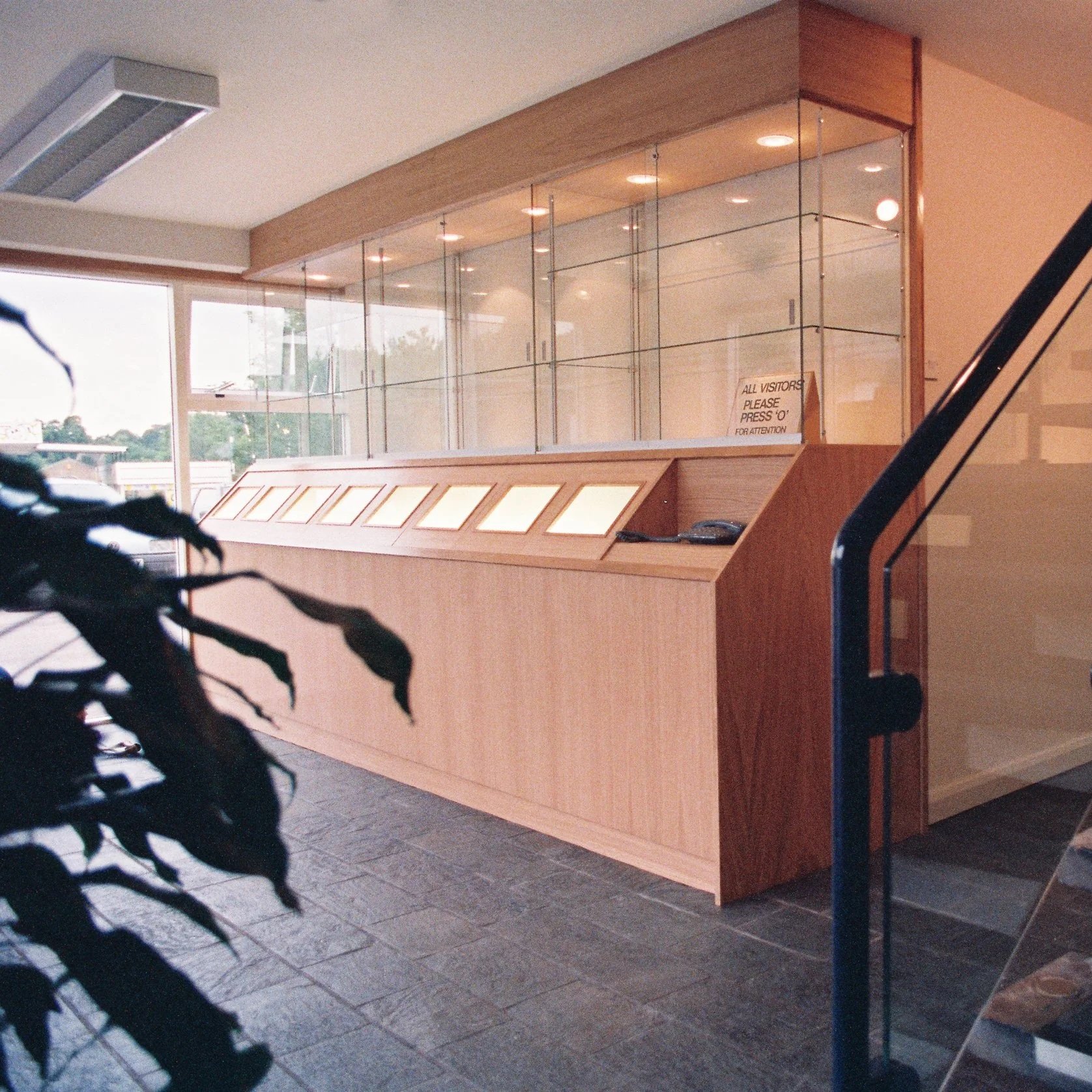 Oak display case with illuminated transparency display and glazed shelving.