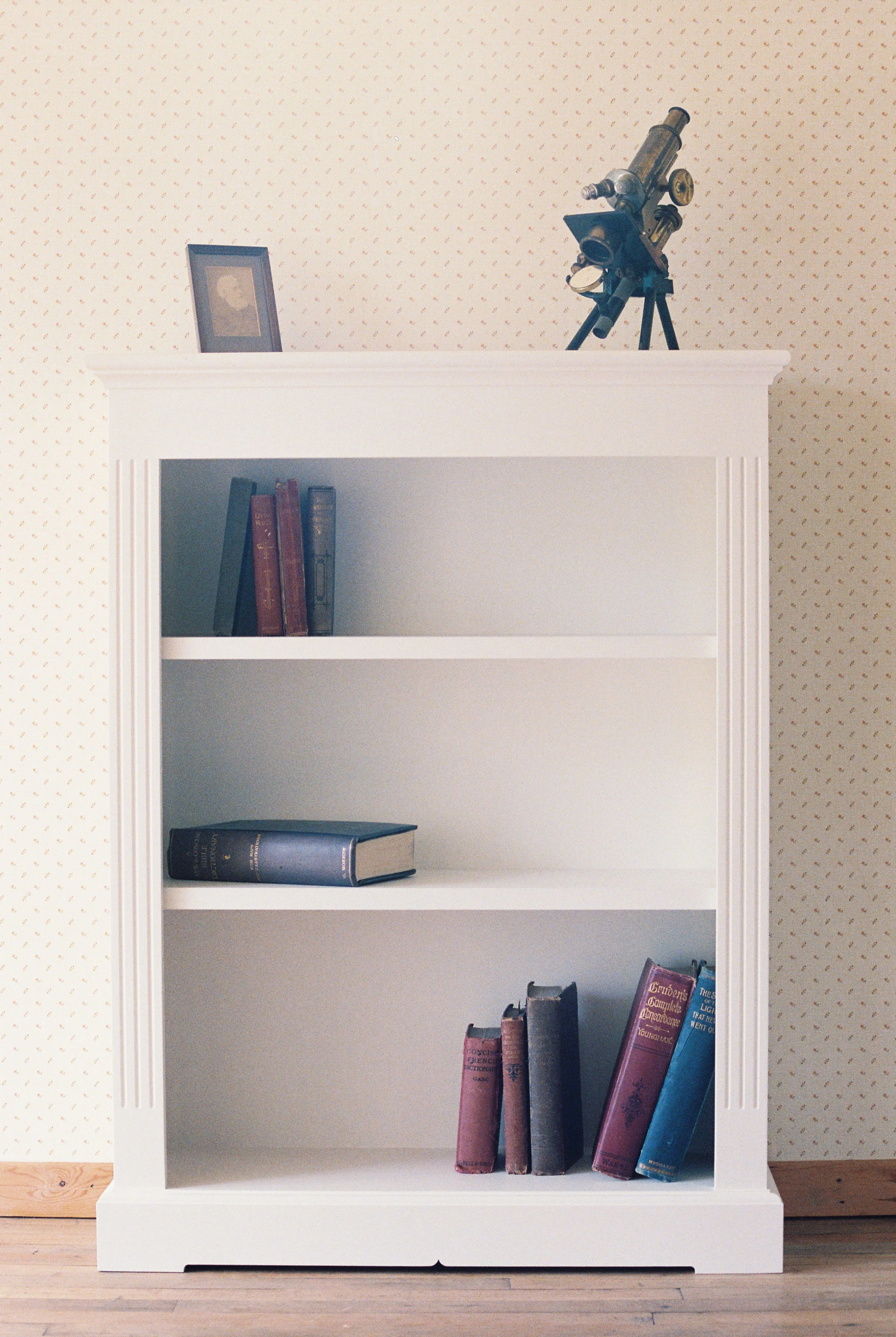 White painted bookshelf with two adjustable shelves.