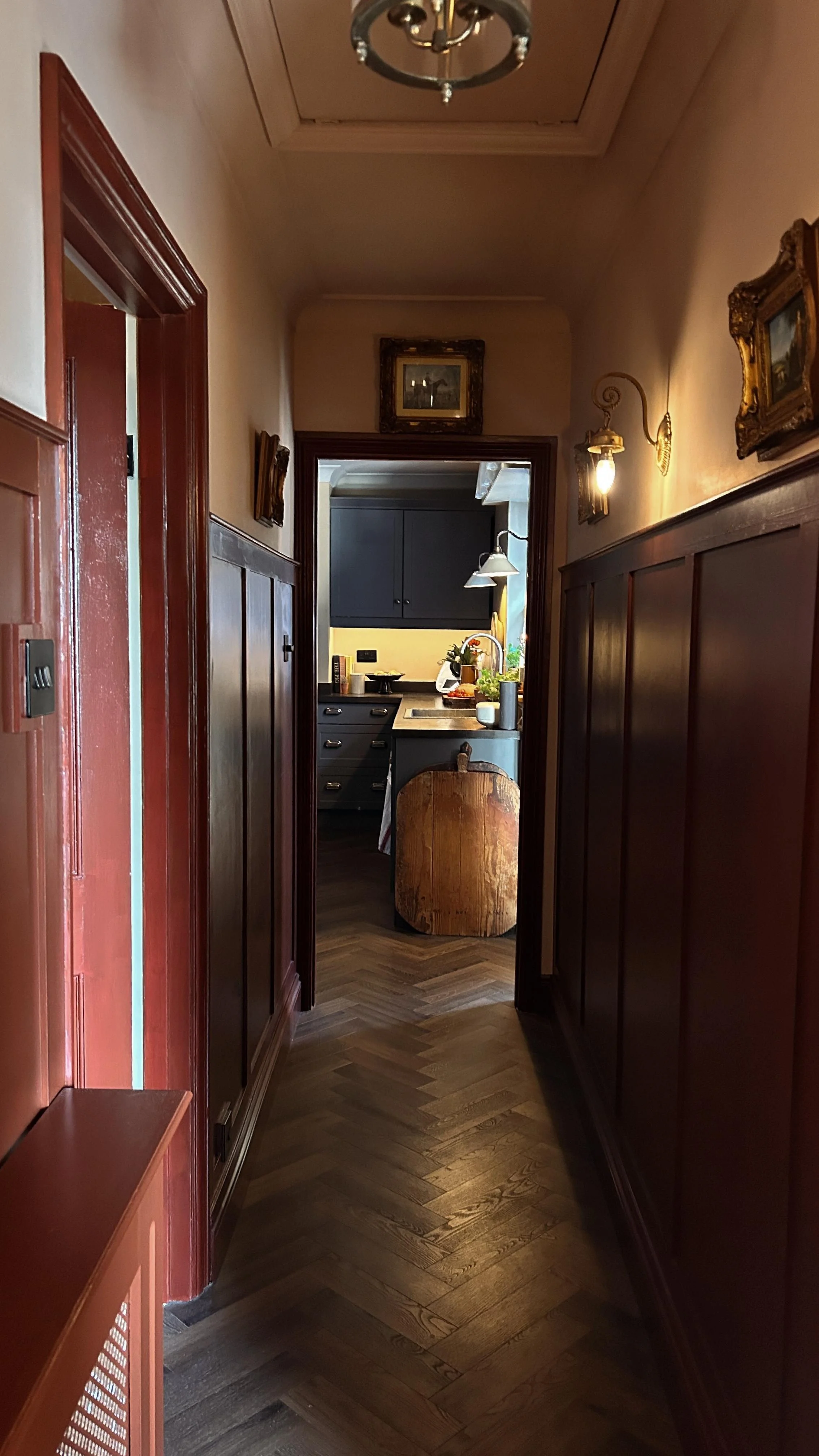 Fitted kitchen and wood panelling to hallway.