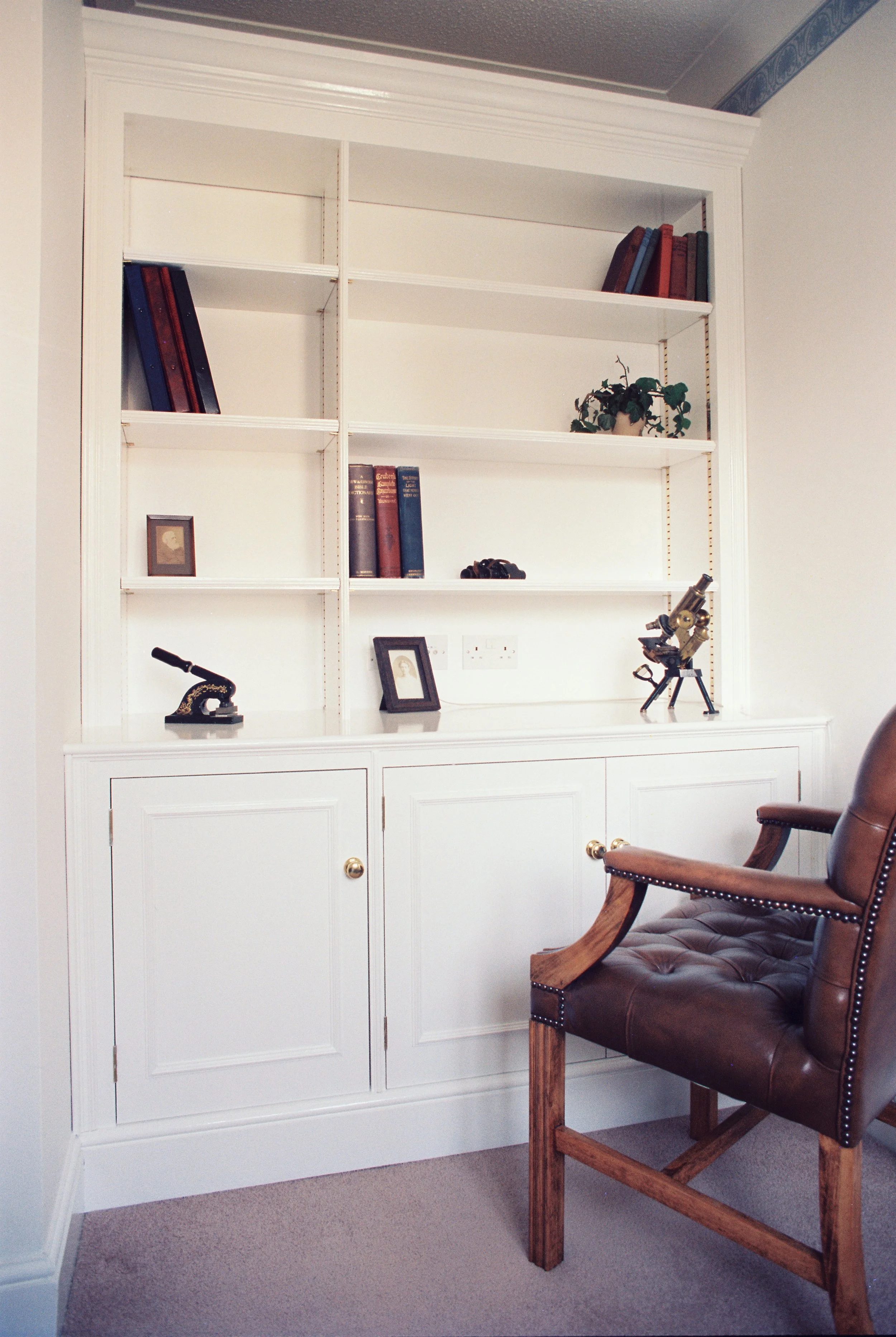White painted built-in cupboard/bookcase.