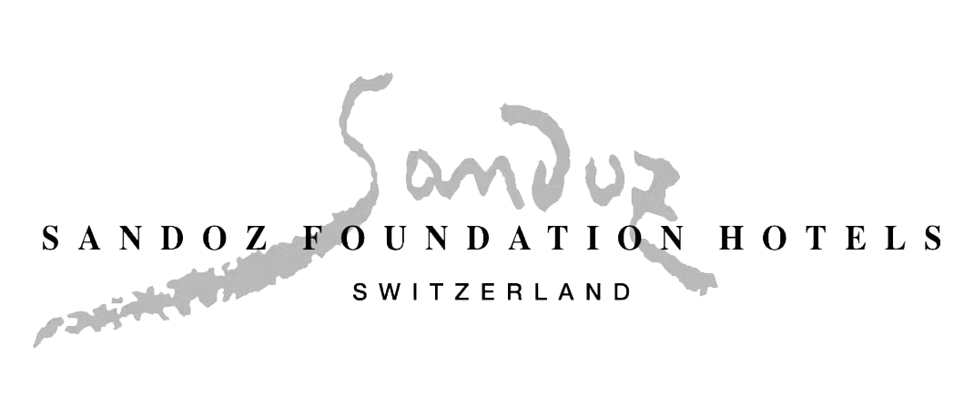 Logo of Sandoz Foundation Hotels Switzerland with stylized gray signature design.