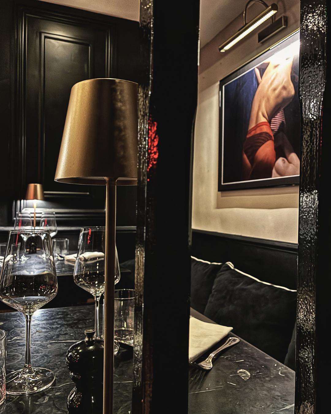 Elegant interior of Fadiga Bolognese Restaurant in Soho, London, featuring warm lighting, dark wood details, designer furnishings and an intimate Italian dining atmosphere.
